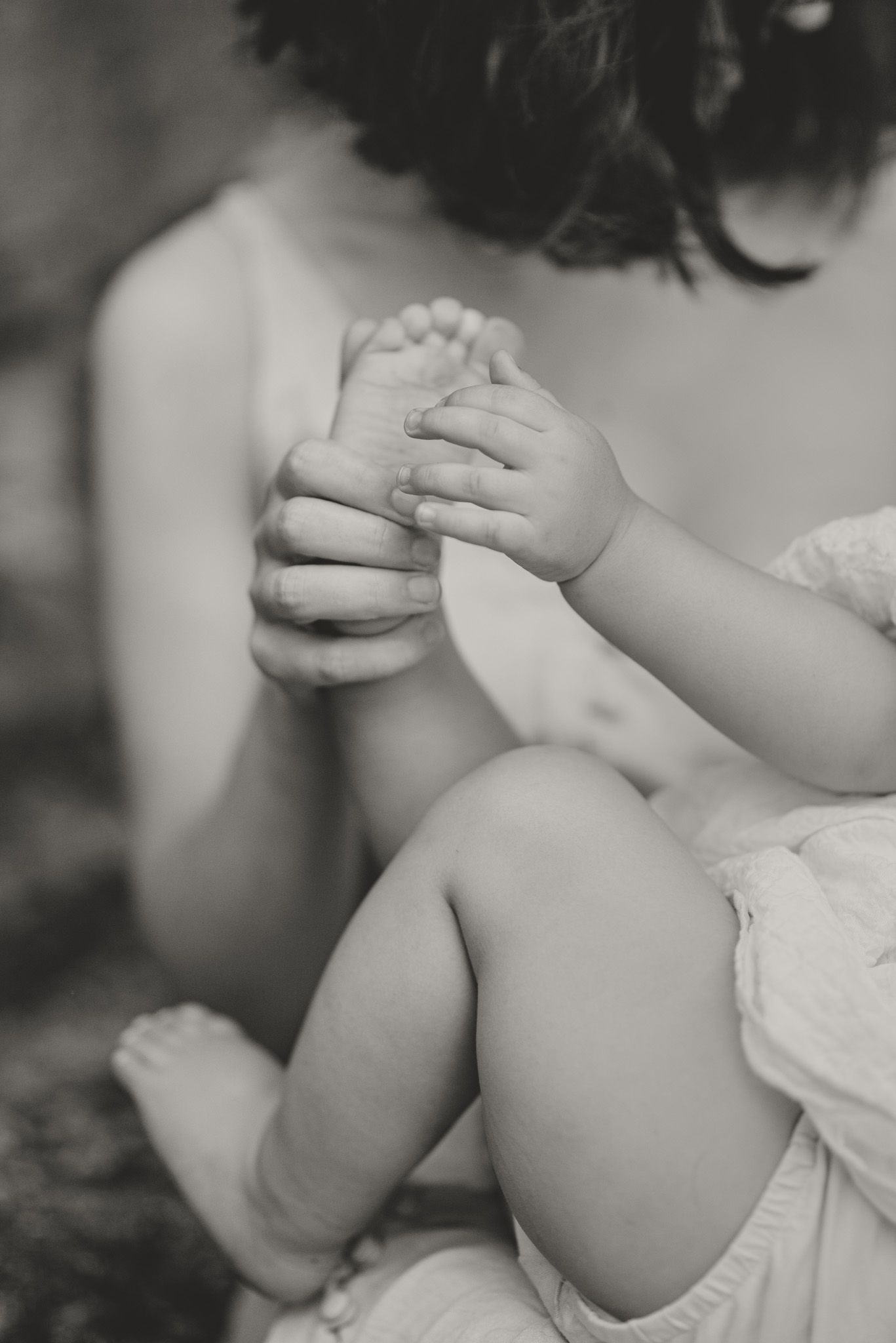 Black and white close-up shots showing gentle hand gestures and tender moments.