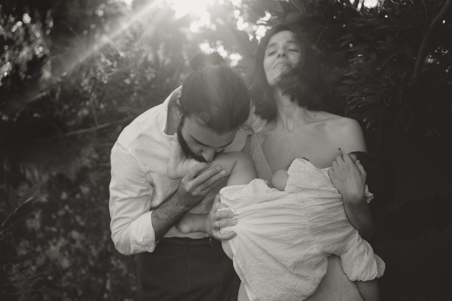 Black and white artistic portrait series capturing intimate close-up expressions in natural sunlight.