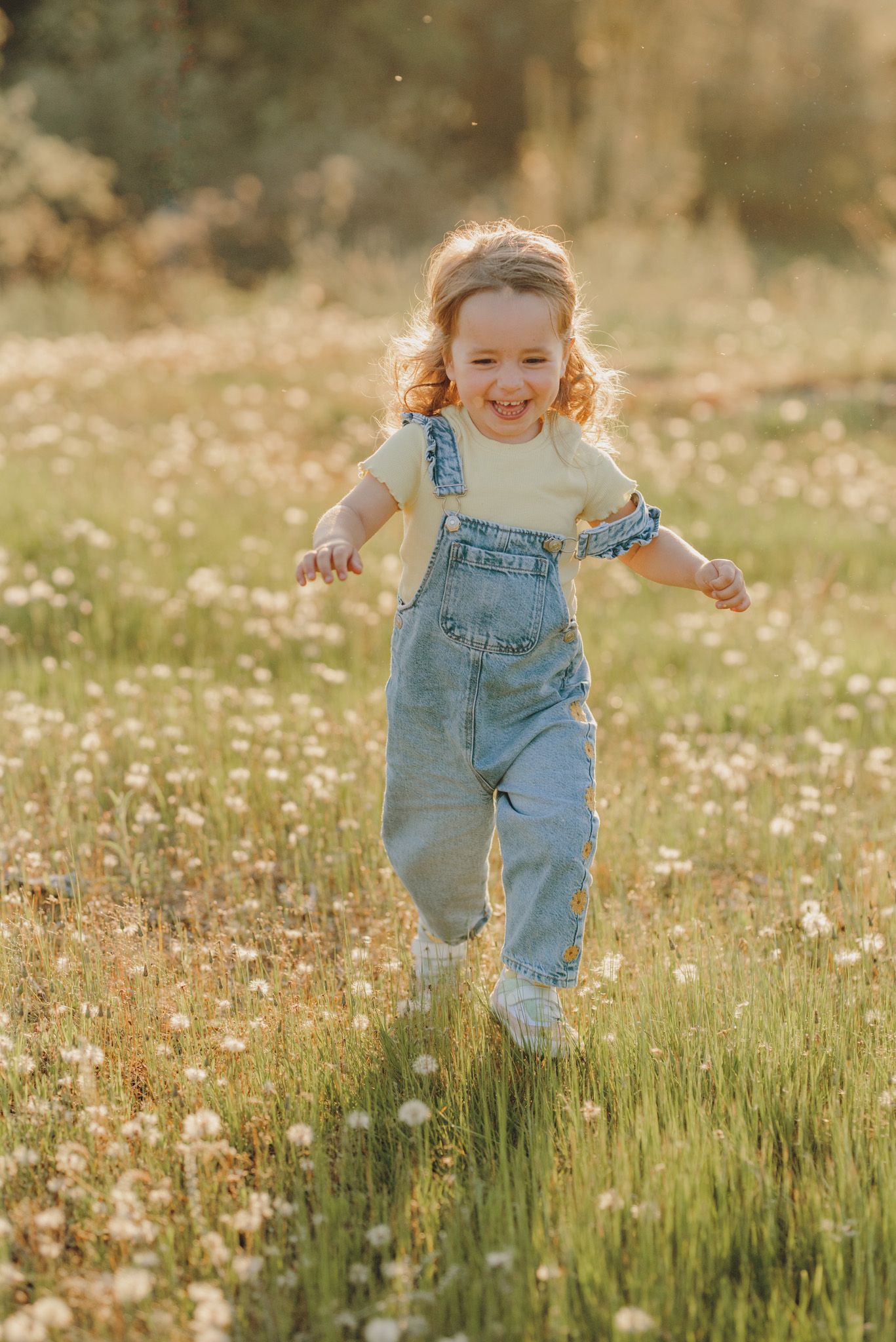 Energetic running and playing in a field of wildflowers at sunset.