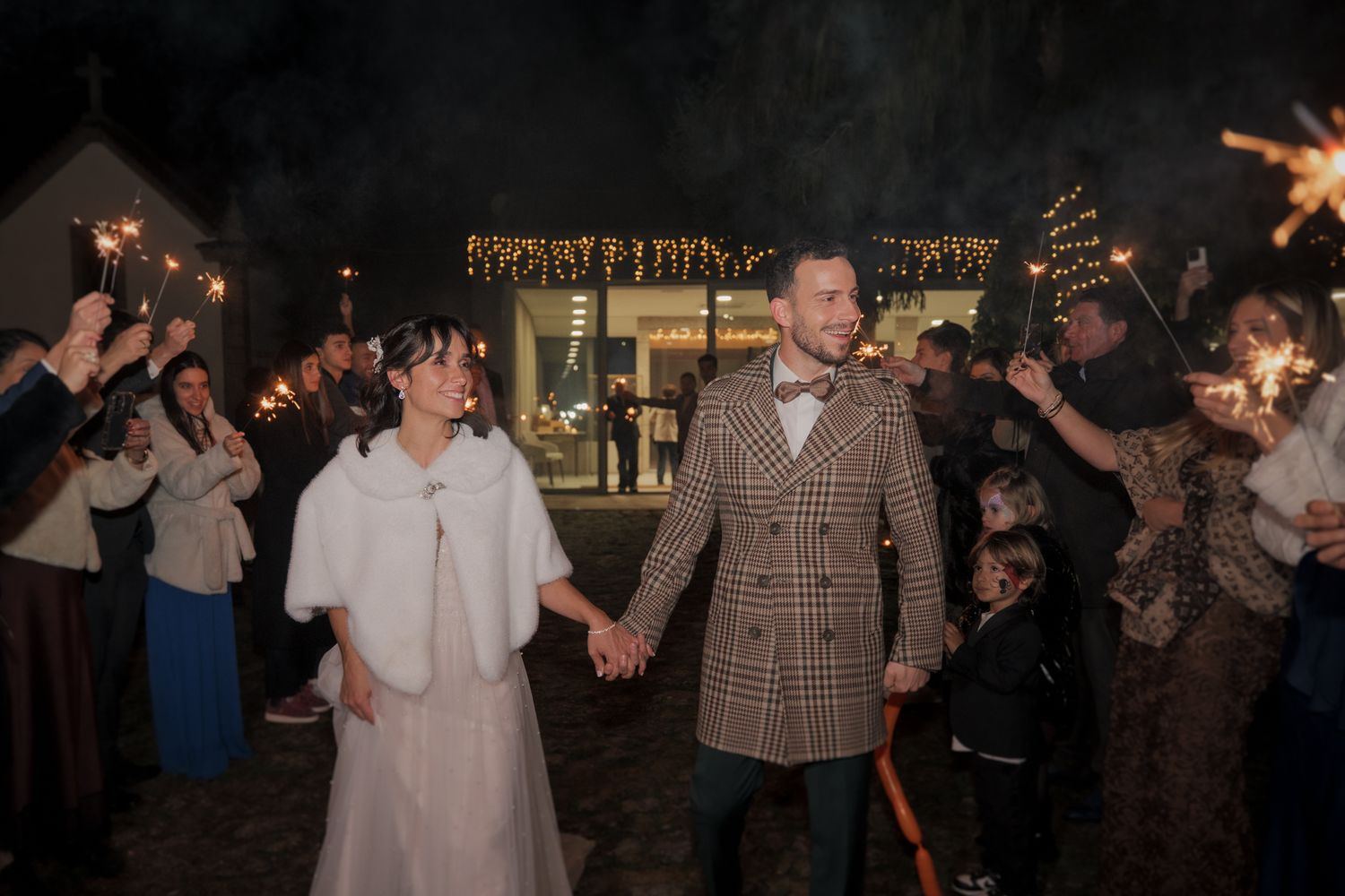 Guests dancing at a dimly lit evening wedding reception.