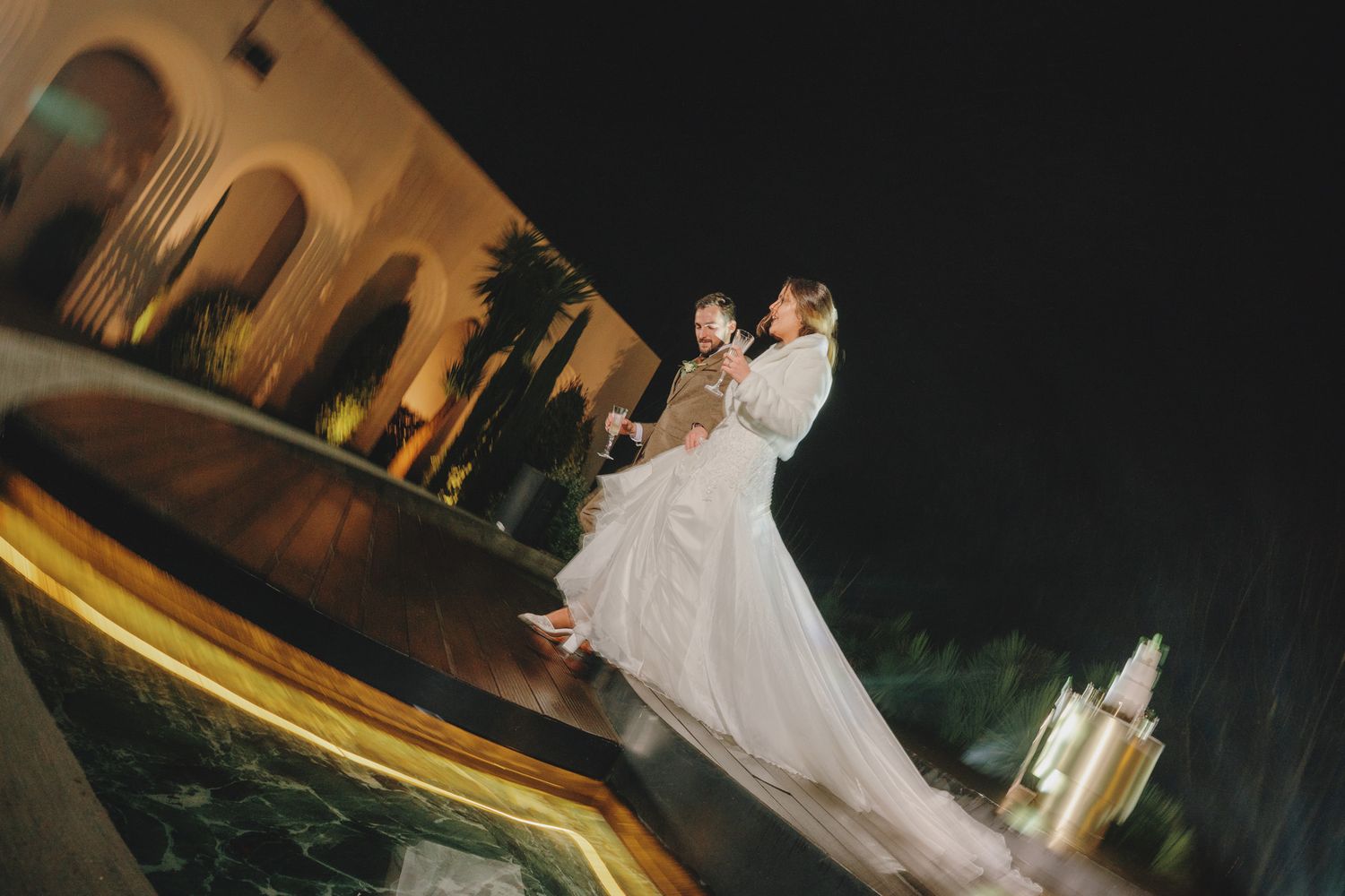 Wedding dance sequence captured at night with dramatic lighting and shadows.