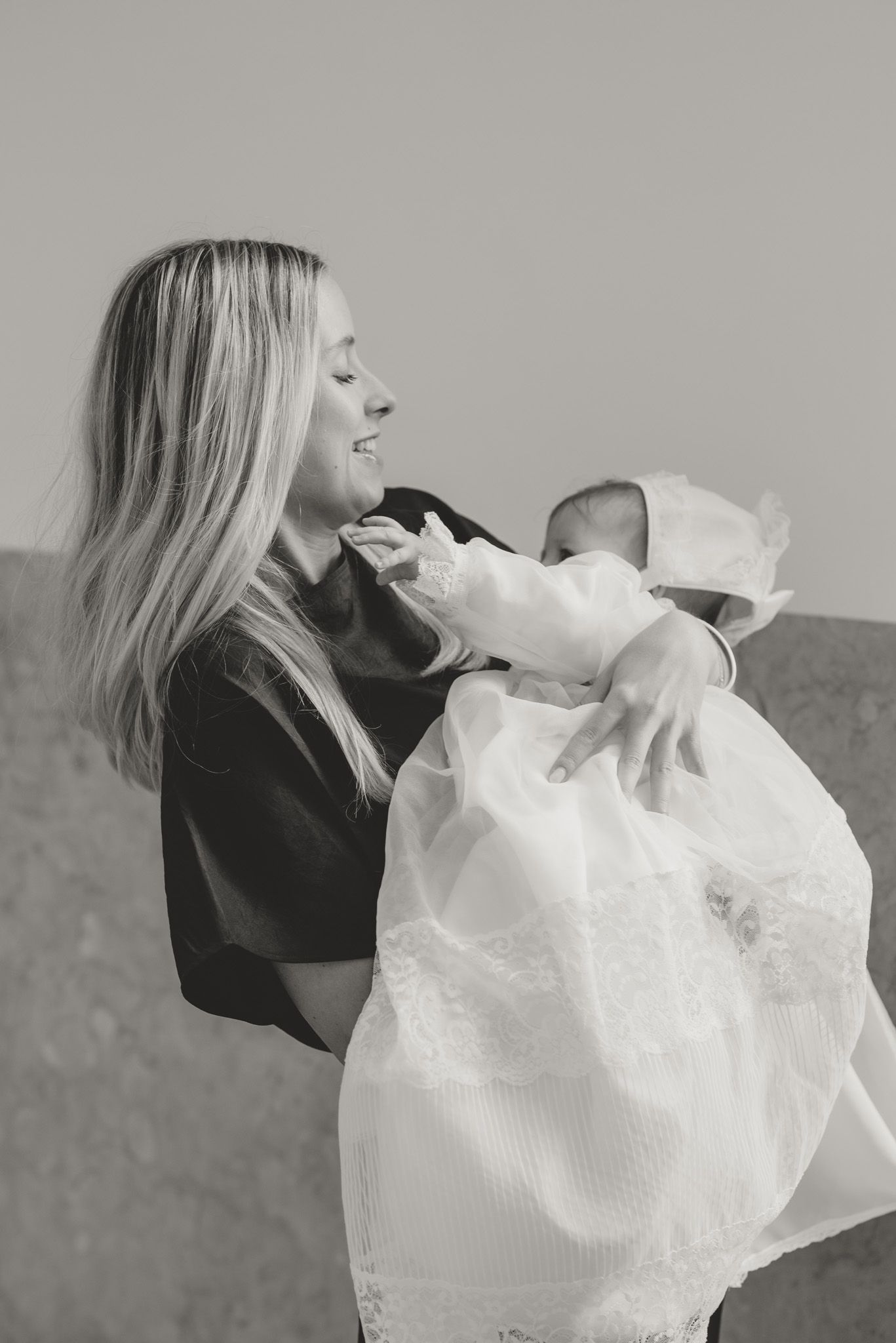 A series of black and white photos showing someone playfully biting into a white fluffy tulle fabric.