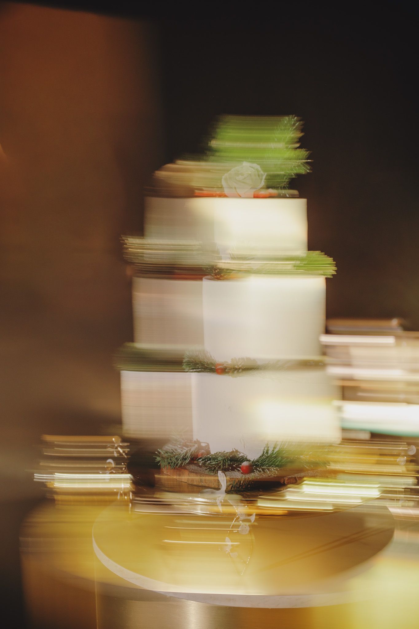 Abstract motion blur of white wedding cake layers with warm lighting effects.