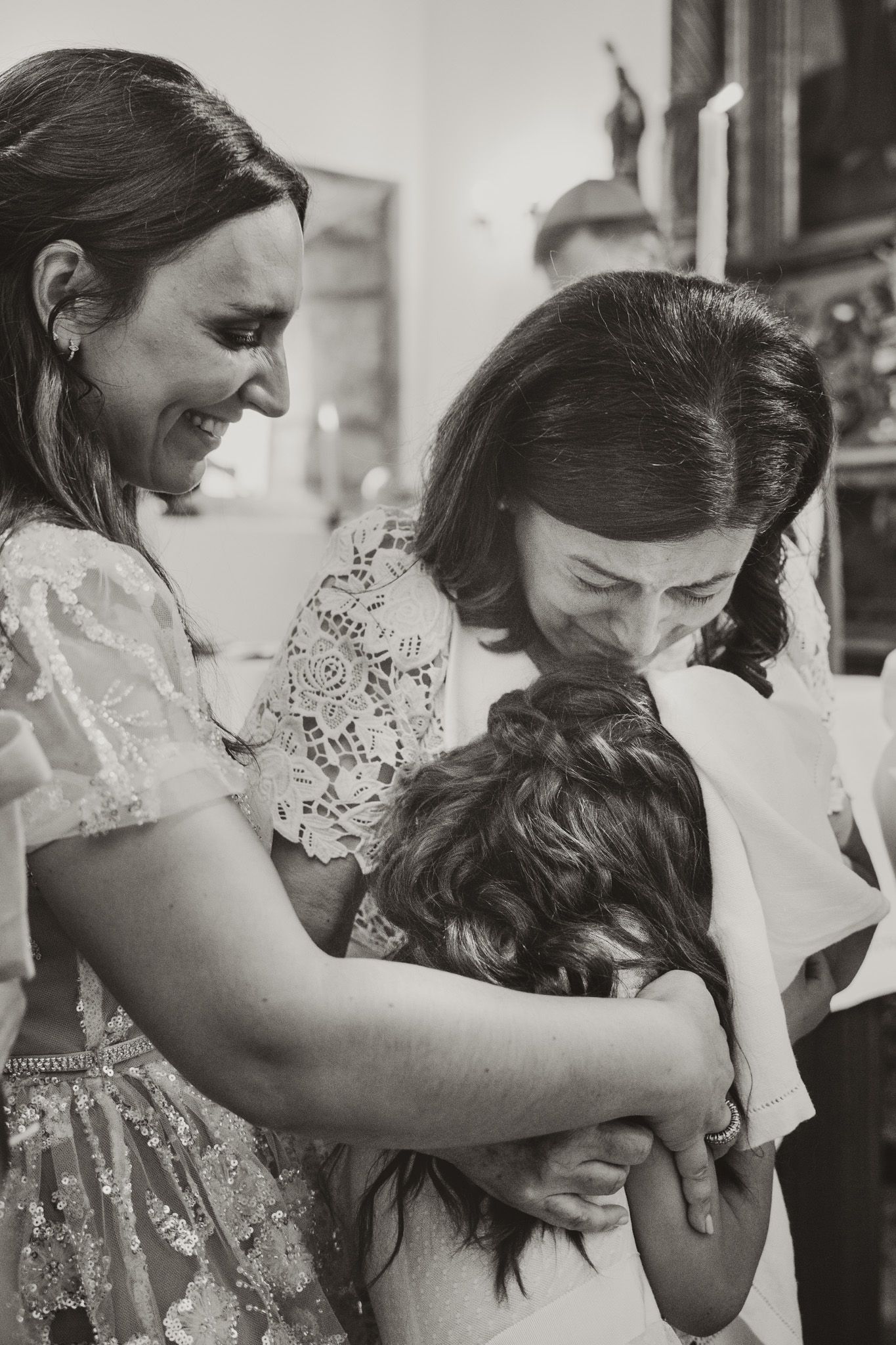 Black and white photos showing tender moments during a baptism ceremony.