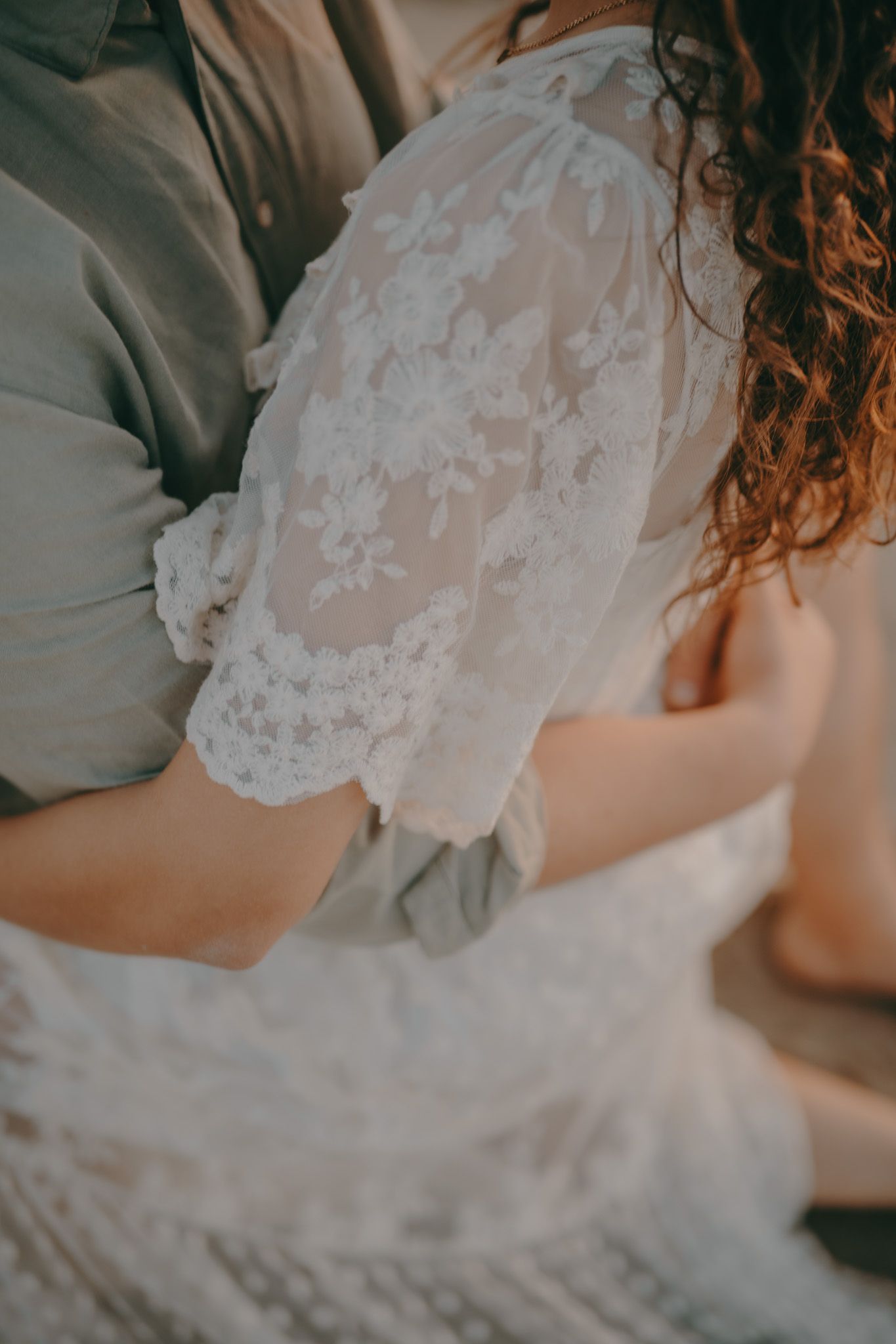 Close-up detail of delicate white lace on a wedding dress.