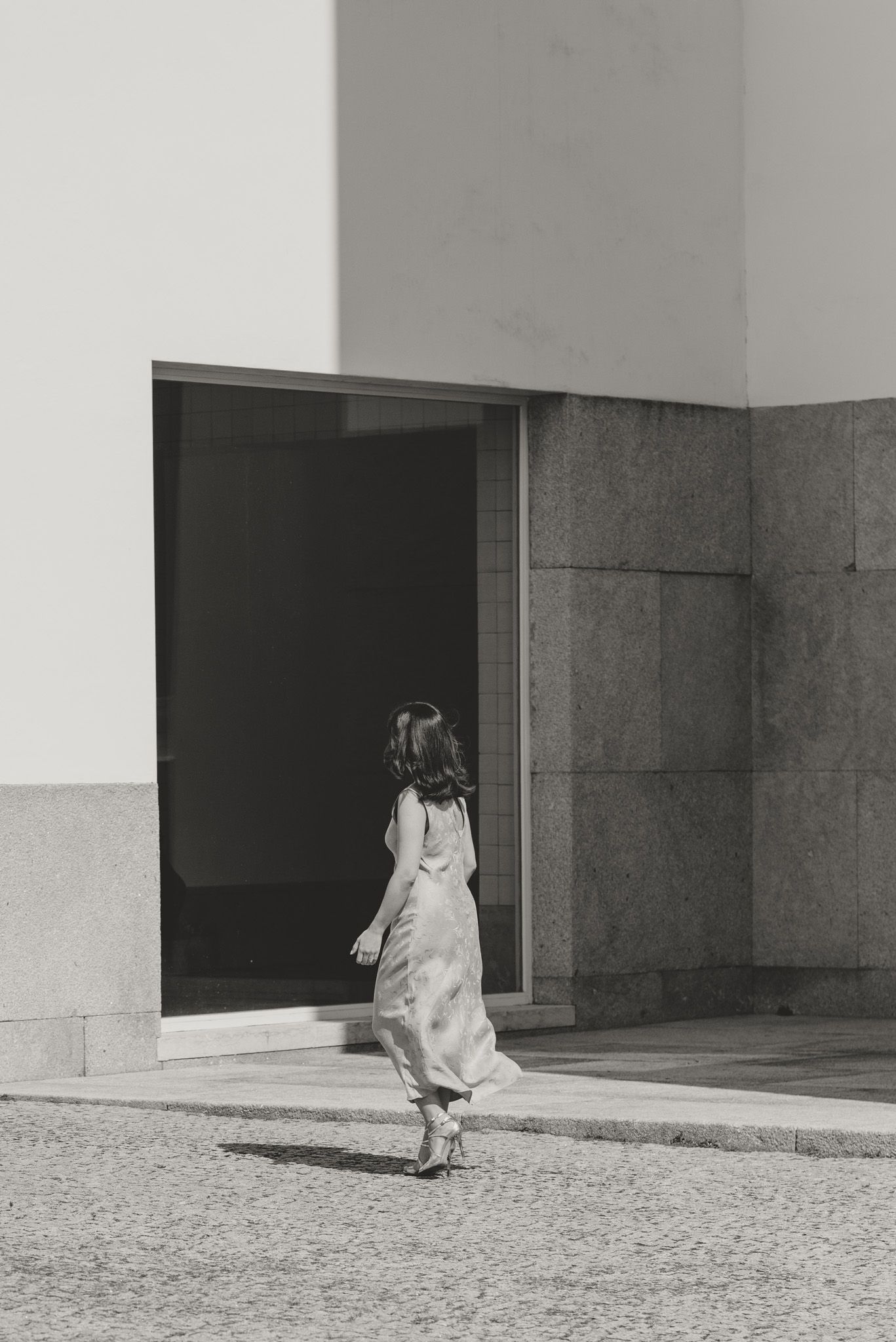 Black and white minimalist architectural series showing a figure and doorway in geometric composition.
