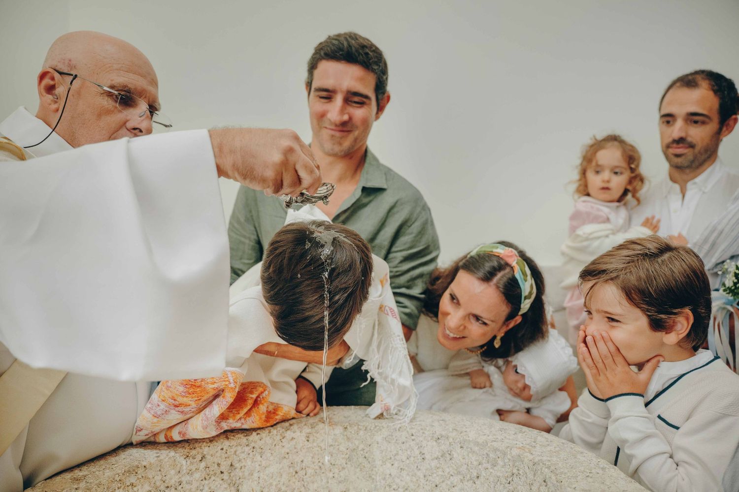 A series of black and white photographs showing tender moments between parents and newborn babies in a hospital setting.