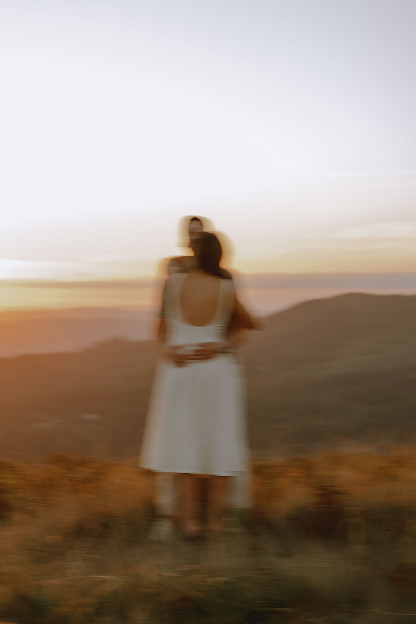 A series of ethereal photos showing a figure in a white dress standing against a misty mountainous landscape at sunset.