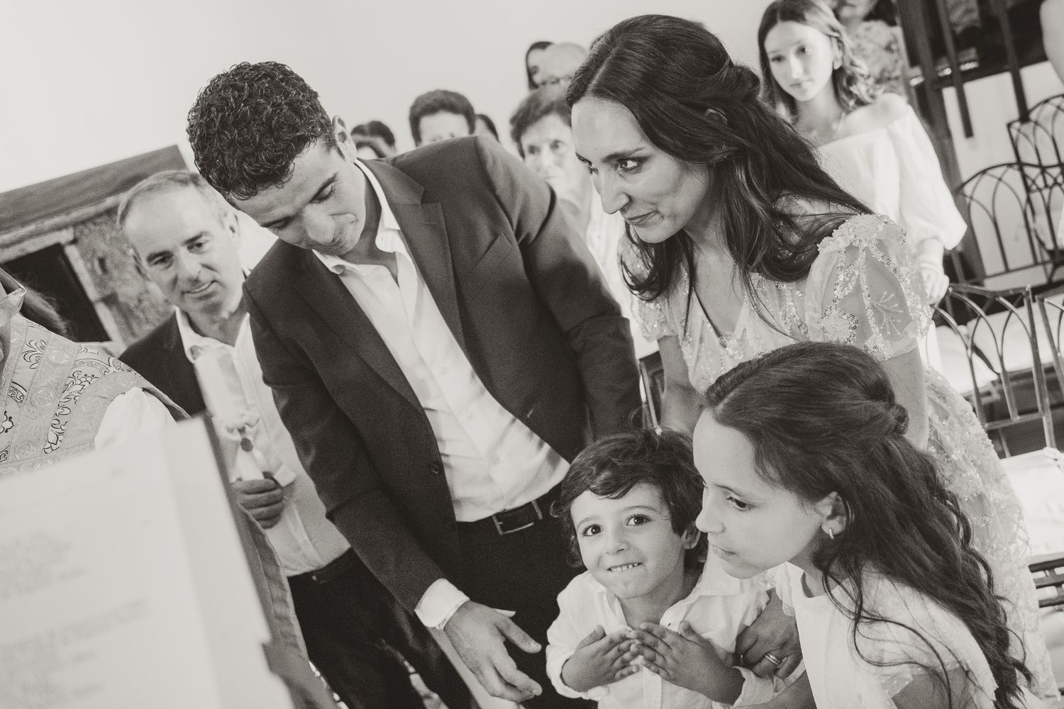 Black and white candid shots of guests at a religious celebration.