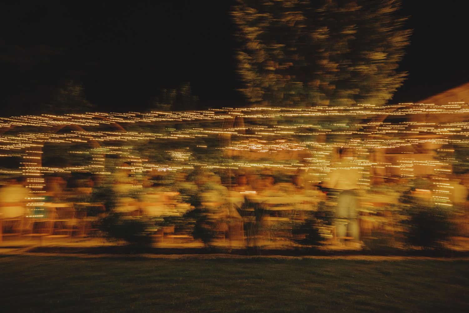 Abstract motion blur of golden lights creating a dreamy nighttime atmosphere.