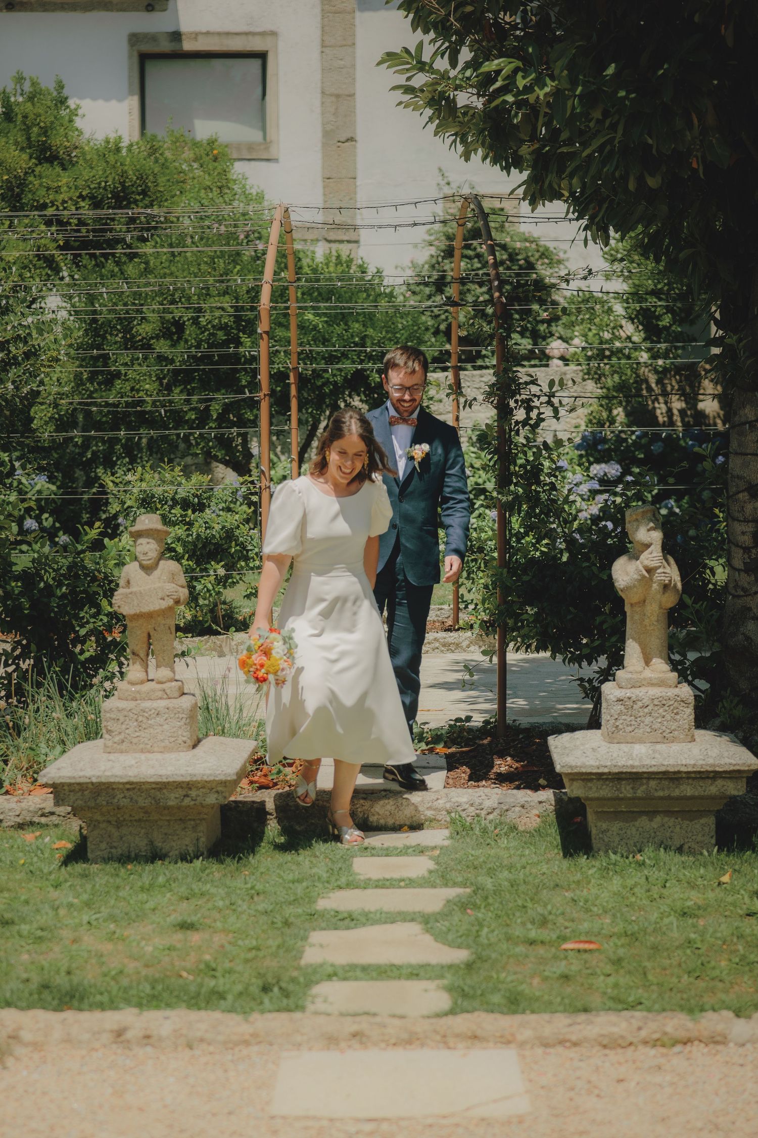 A series of four vintage-style photos showing a couple on stepping stones in a garden with decorative statues.