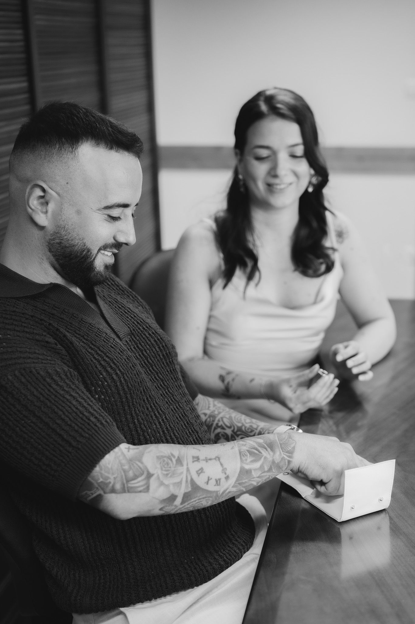 Intimate black and white photos of a couple looking at something together.