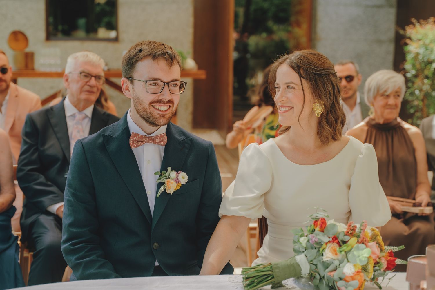 Wedding celebration candid moments captured on an outdoor deck with natural lighting.