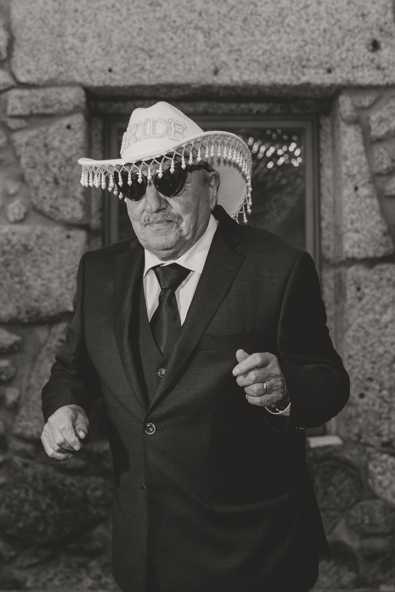 Men in black suits and sombreros pose for a festive black and white photo.