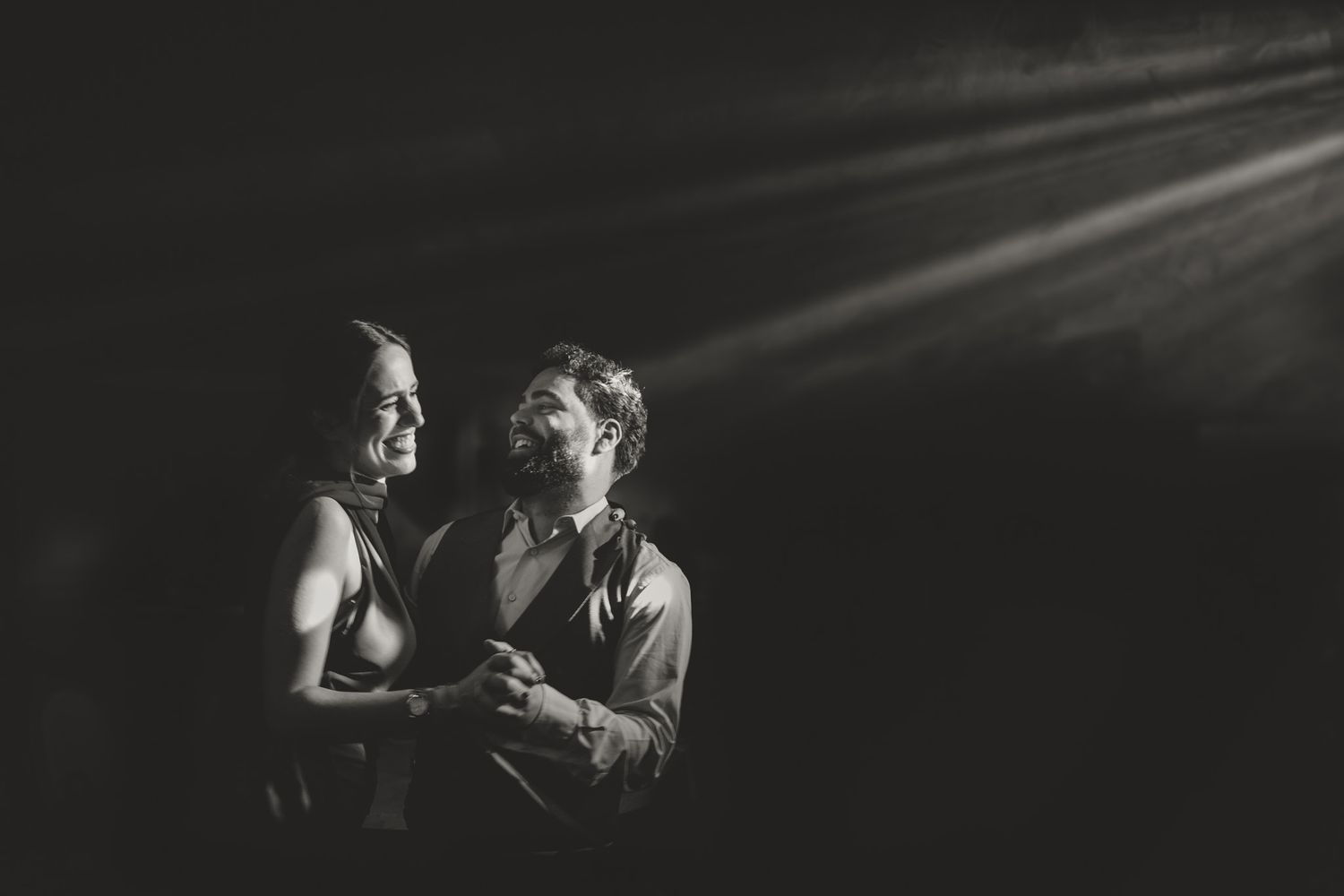 Dark and moody candid photos capture intimate moments during wedding celebration.