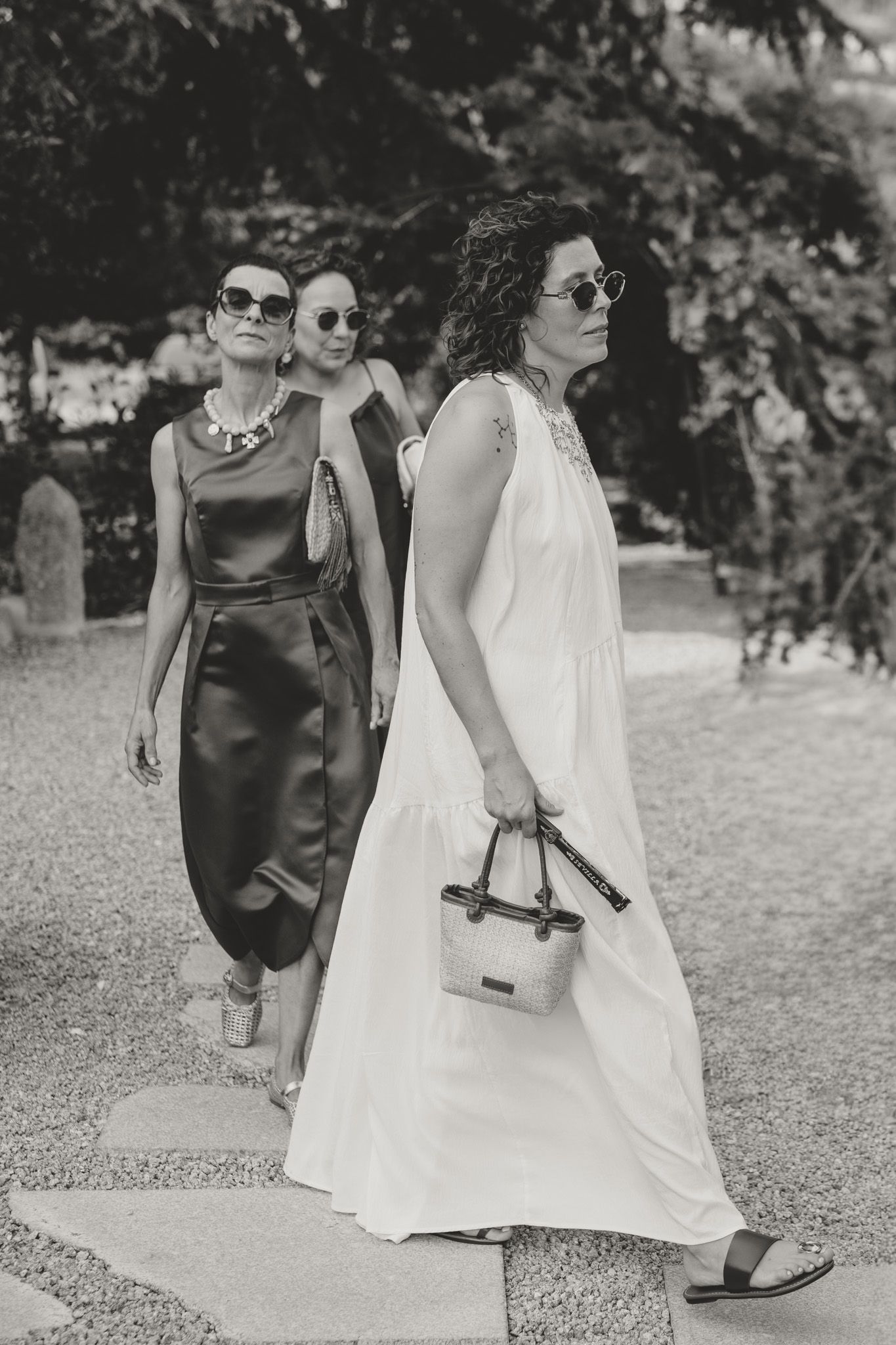 Wedding party walking outdoors in black and white formal attire.