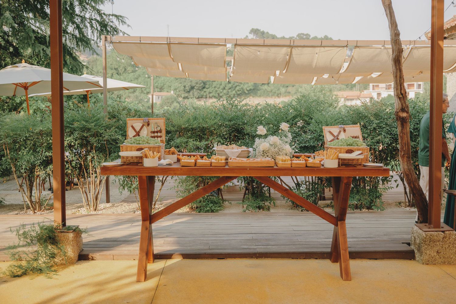 Wooden pergola structure with string lights creating an outdoor covered space.