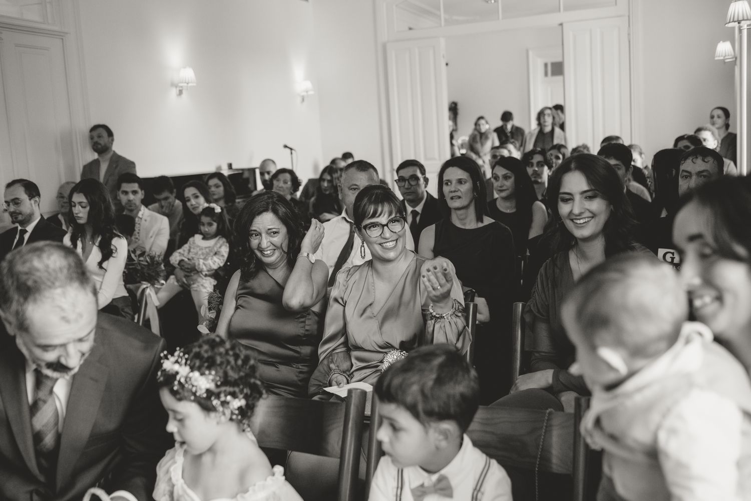 Candid moments of wedding guests showing joyful reactions during the ceremony.