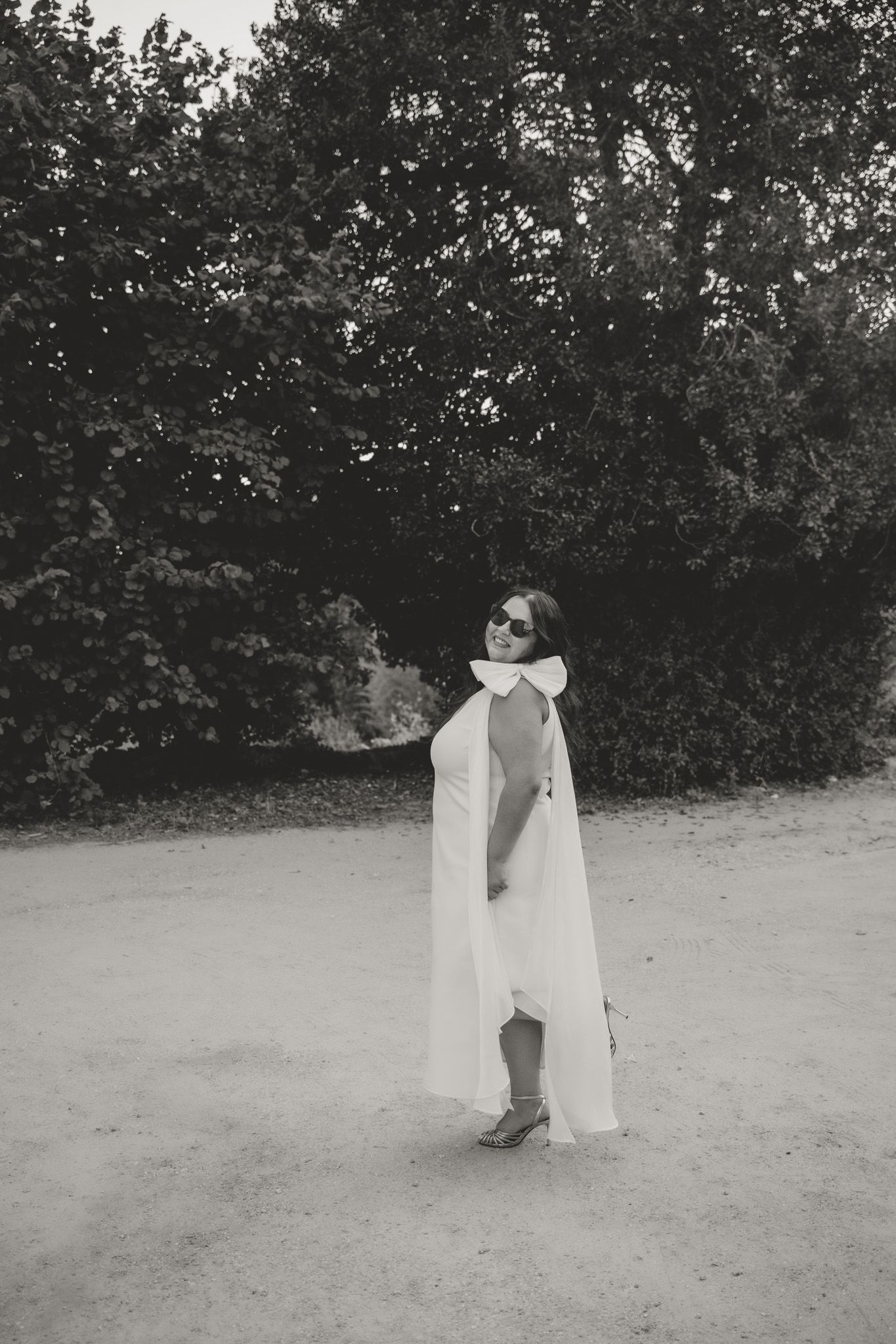 Black and white photography sequence showing romantic moments in an outdoor garden setting.