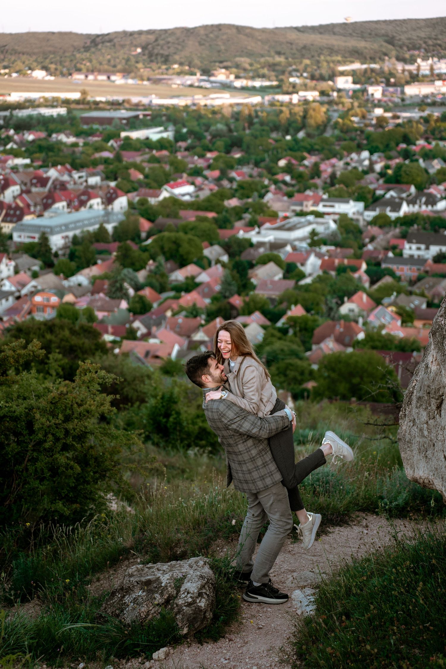 Scenic panoramic sequence of people taking photos at sunset overlooking a residential neighborhood from a hilltop viewpoint.