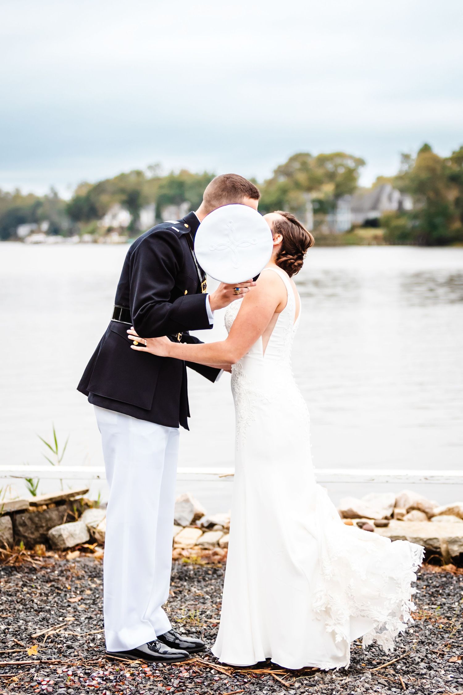 Intimate waterfront wedding moment captured against a coastal background.