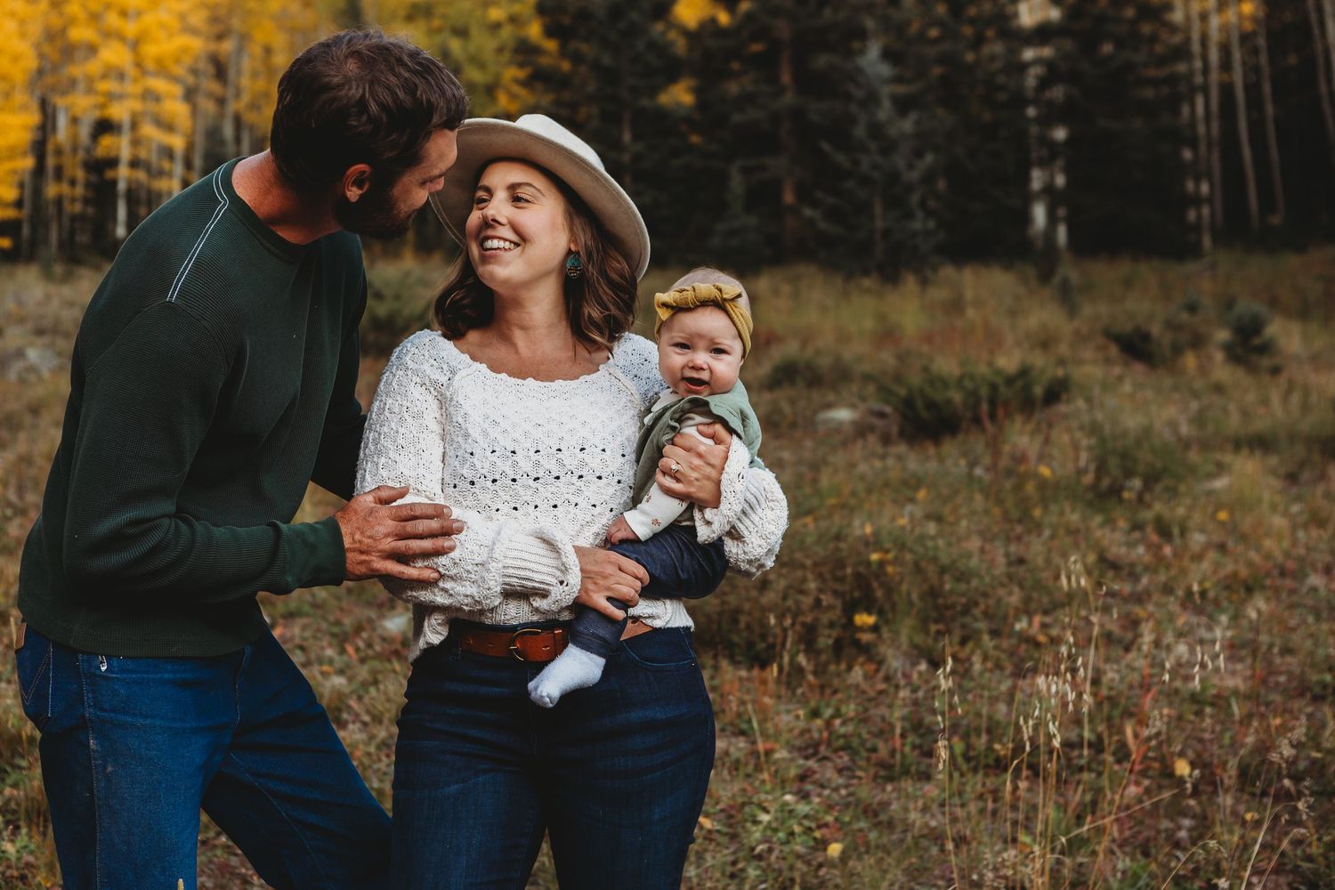 Joyful family sharing intimate moment in autumn mountain setting.