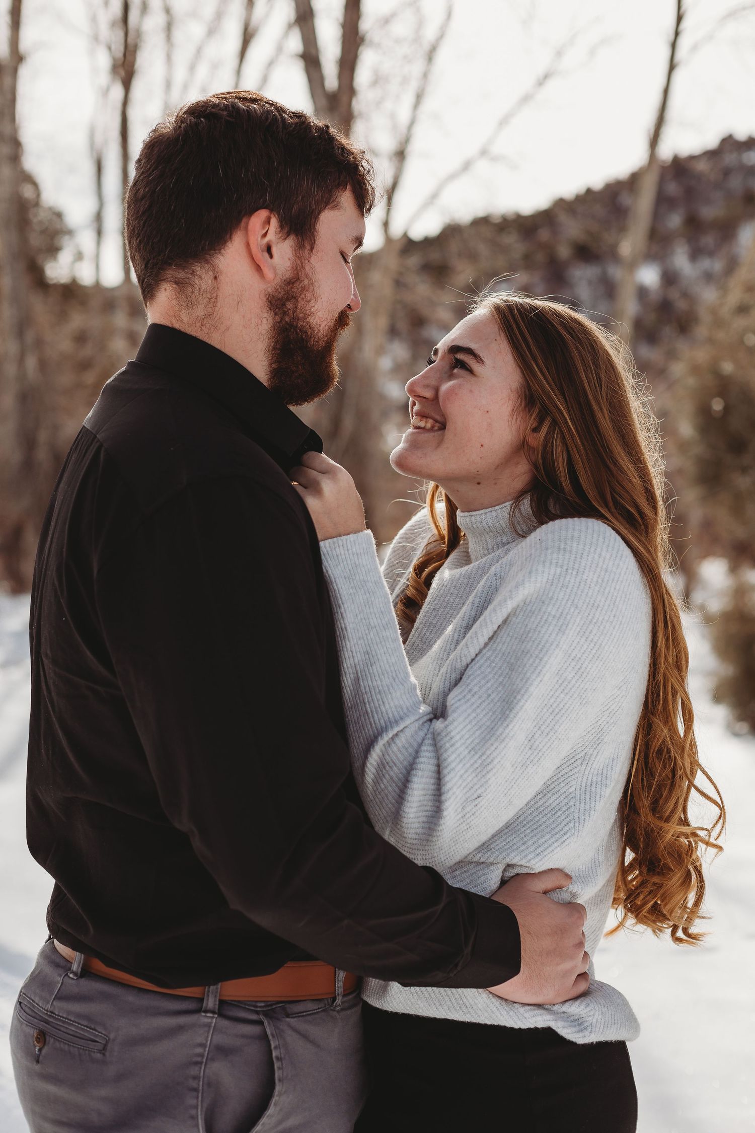 Candid laughter shared during a winter photoshoot.