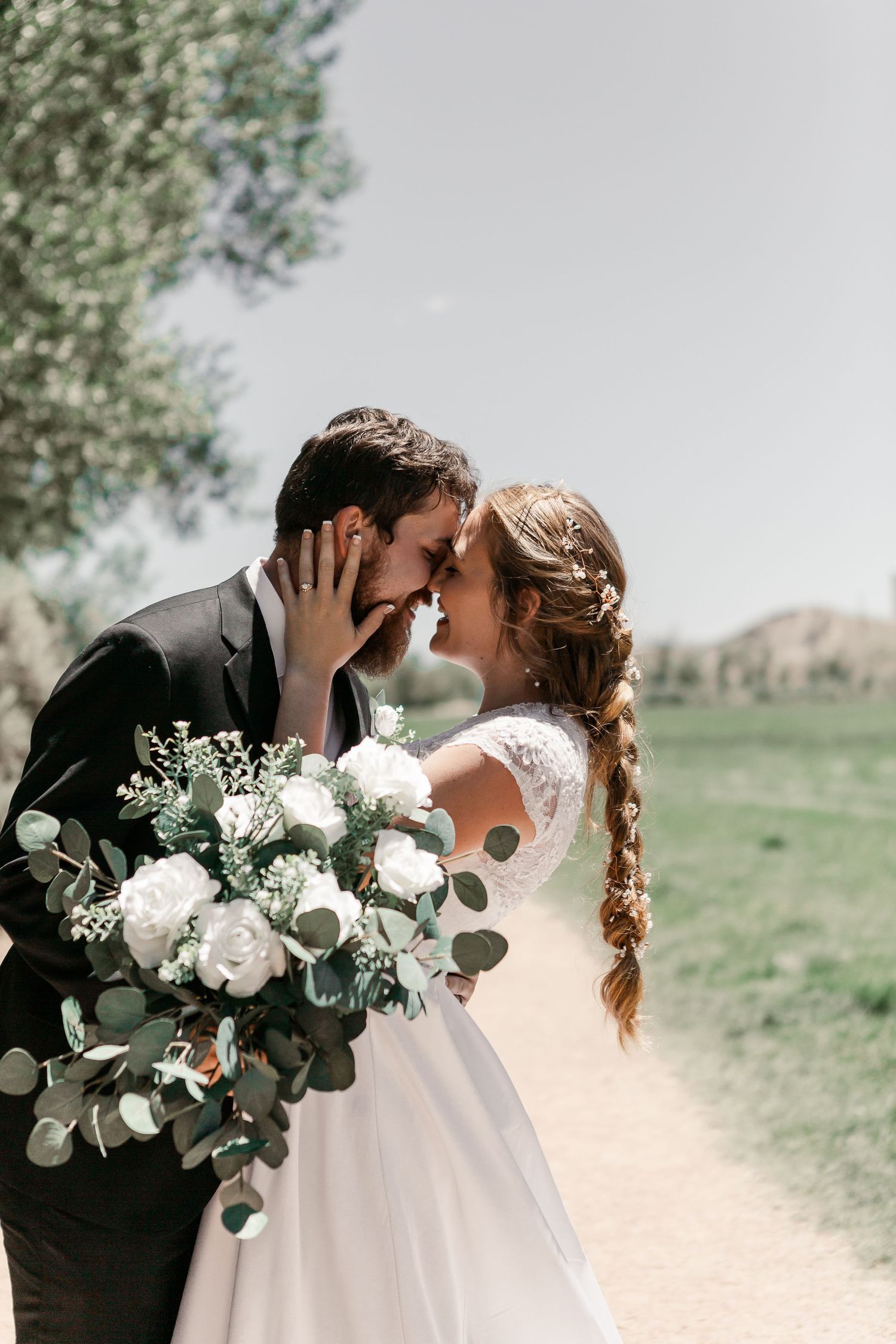 A romantic wedding portrait with a beautiful white and eucalyptus bouquet.
