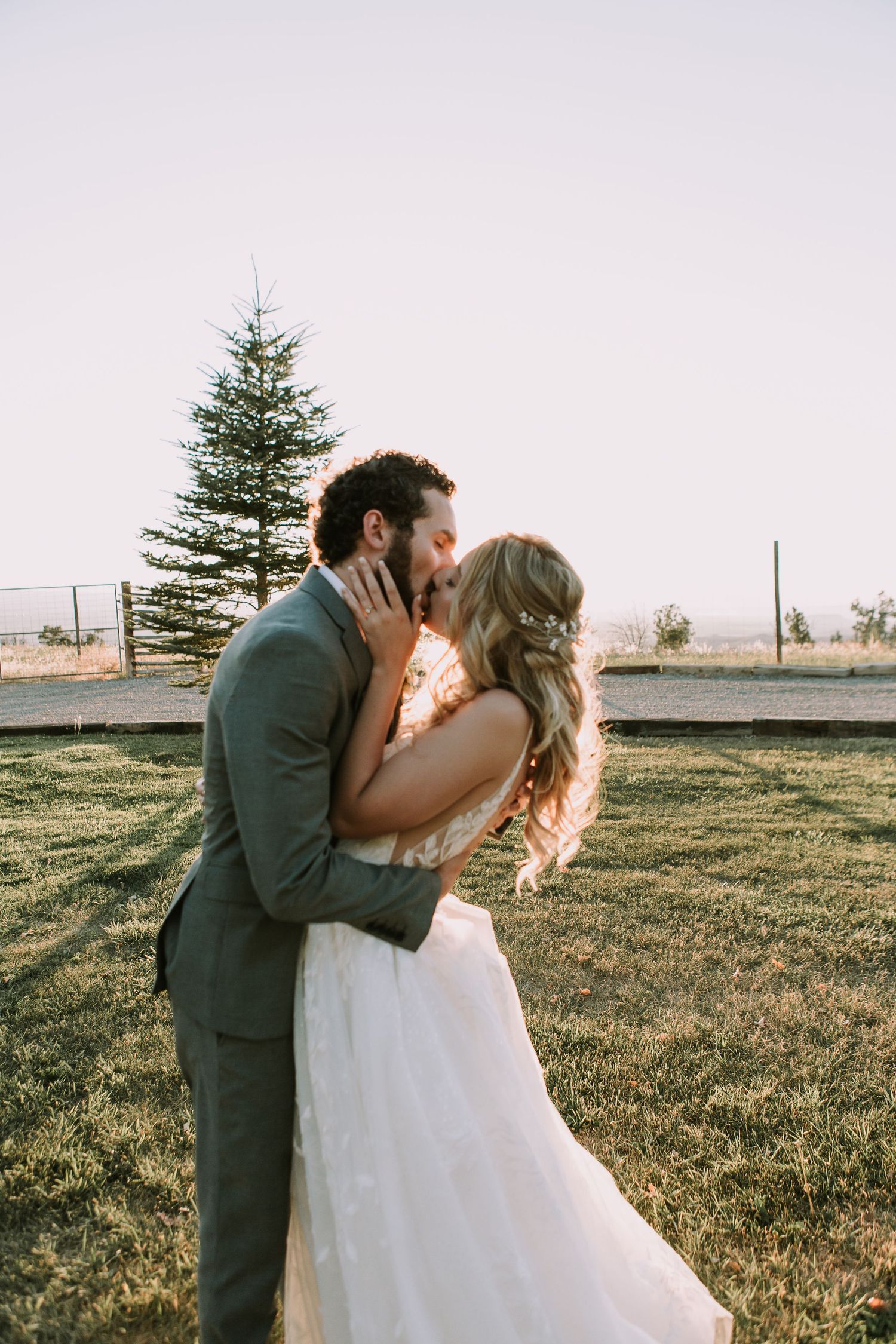 Beautiful sunset wedding photography with pine tree and natural landscape backdrop.