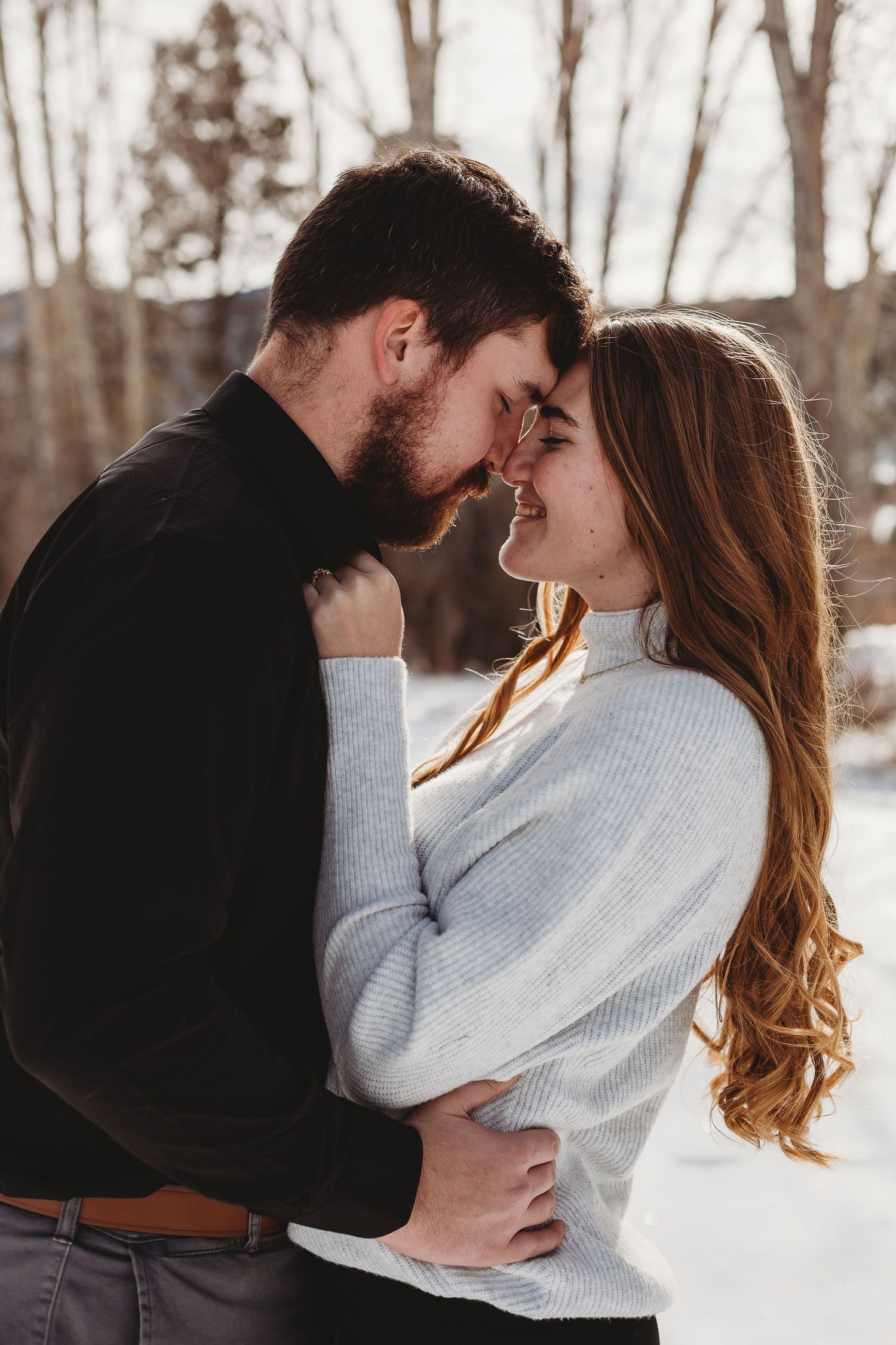Intimate winter moment shared between a couple in the snow.