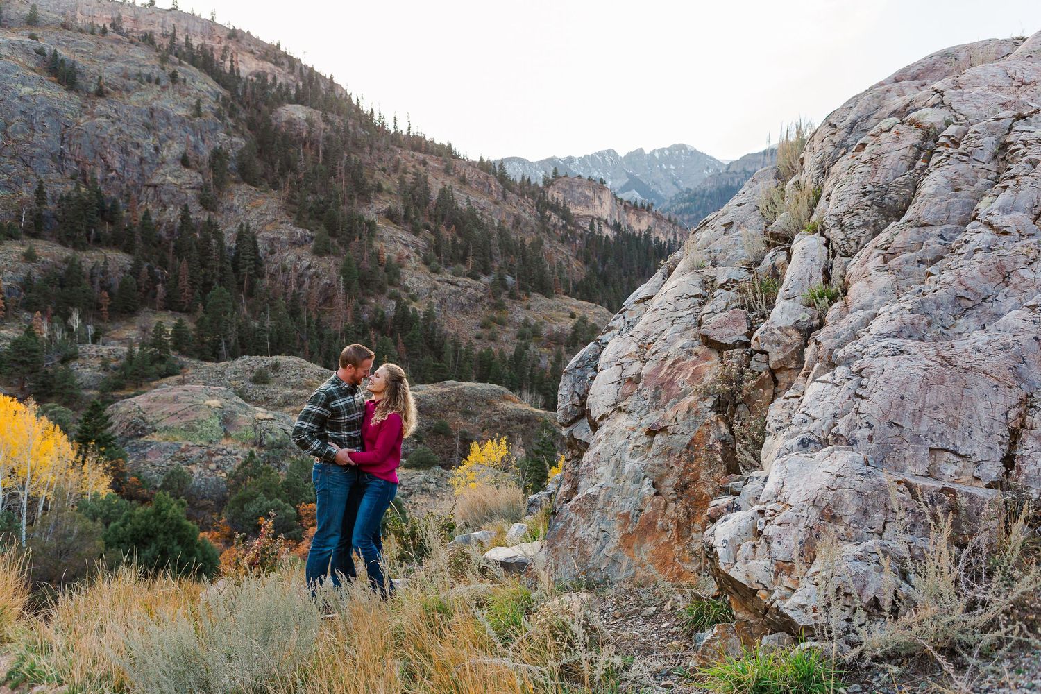 Candid moment captured against rugged mountain landscape with autumn colors.