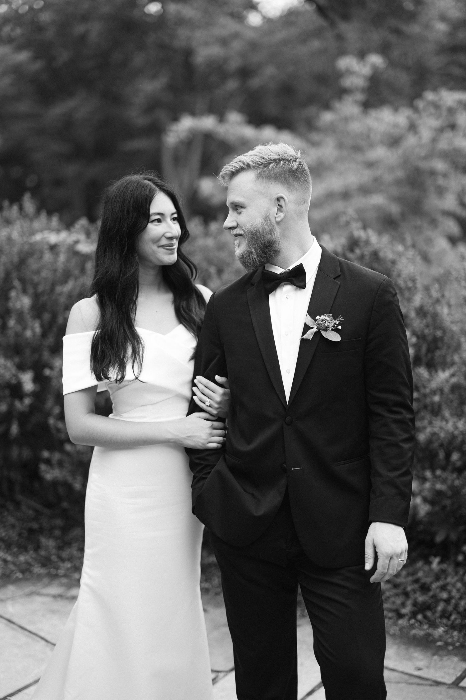 Black and white wedding portraits showing joyful candid moments between newlyweds.