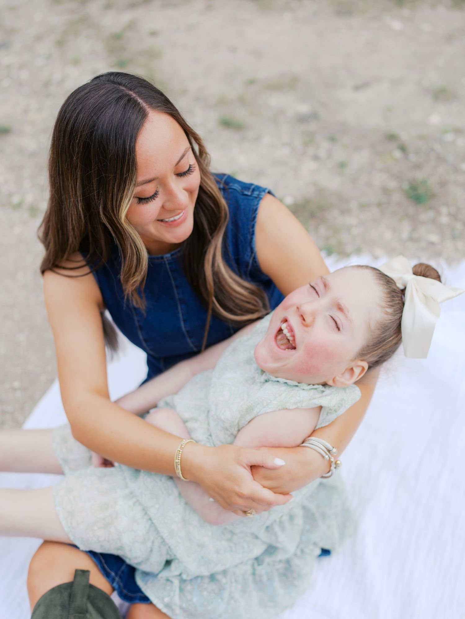 Mother smiling with her young child during an outdoor family photography session