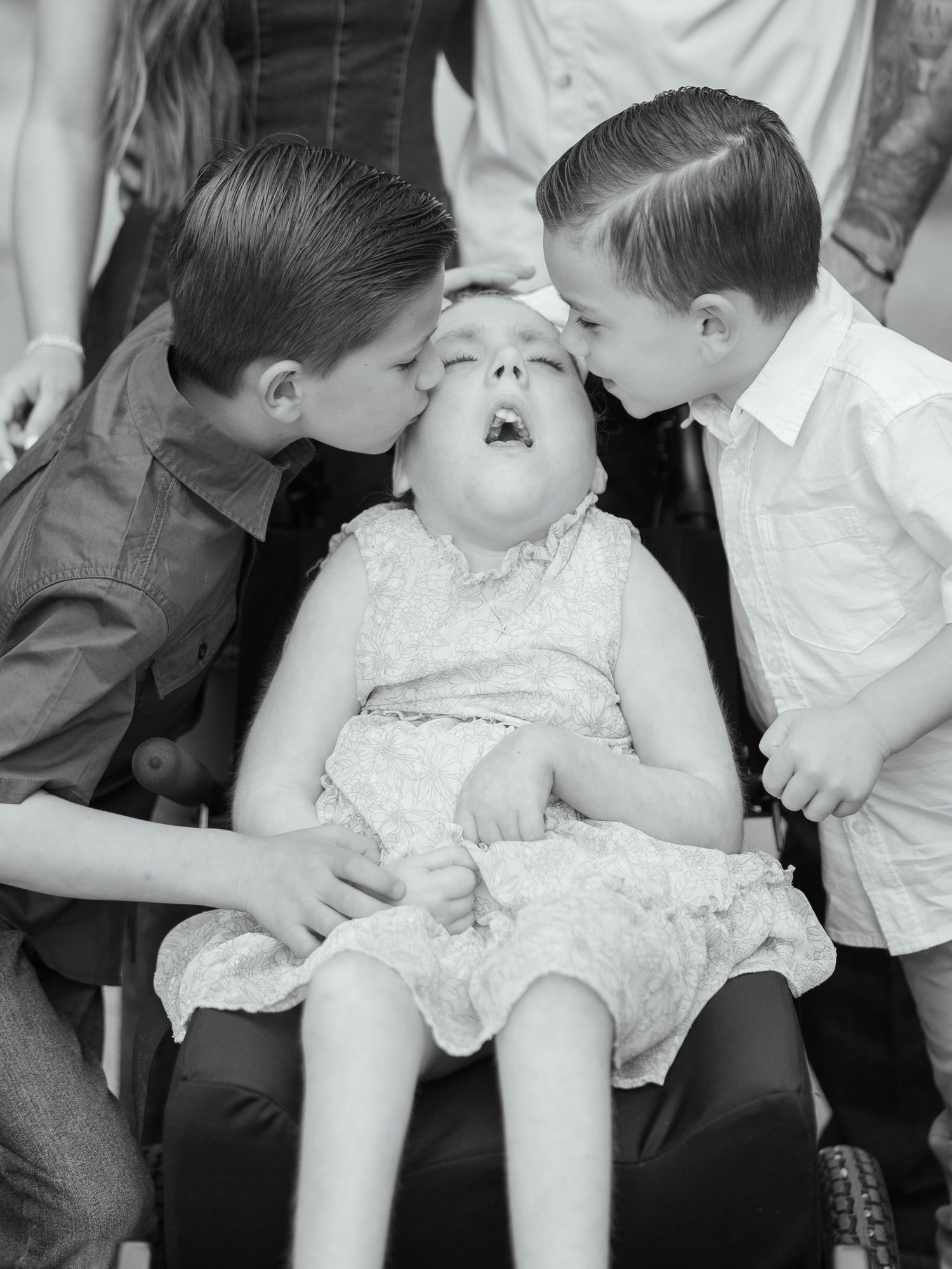 Black and white portrait of three siblings together during a family photography session