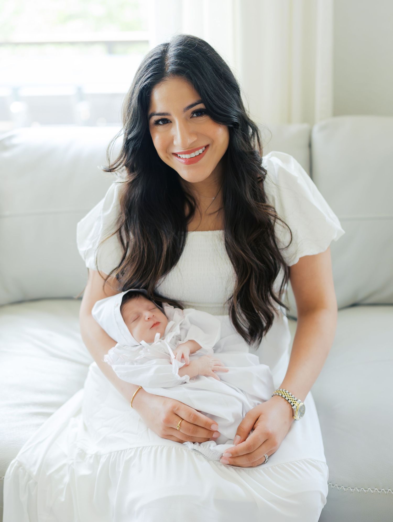 Mother holding her newborn baby during a bright lifestyle newborn photography session in San Antonio