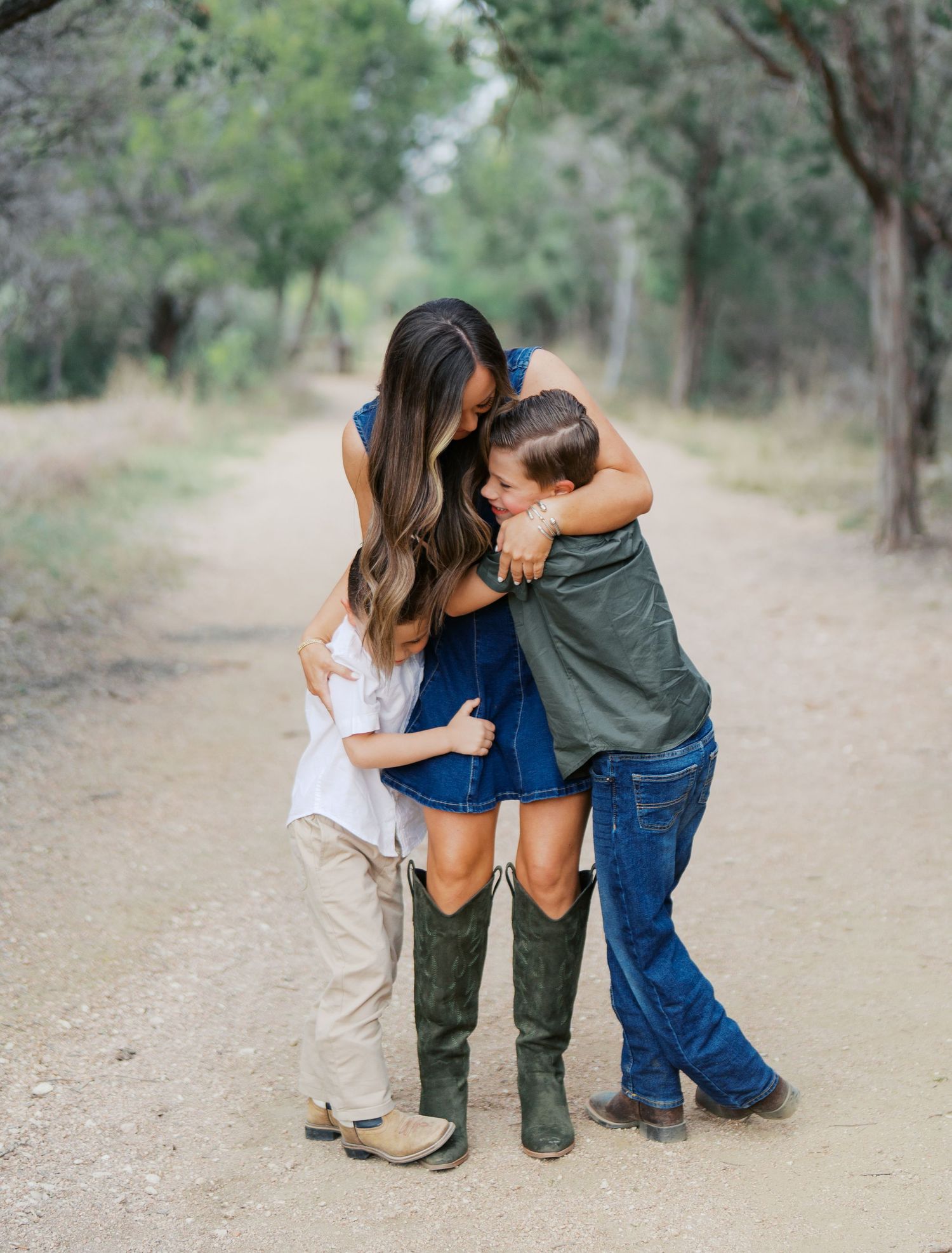 Mother hugging her children during an outdoor family photography session in San Antonio