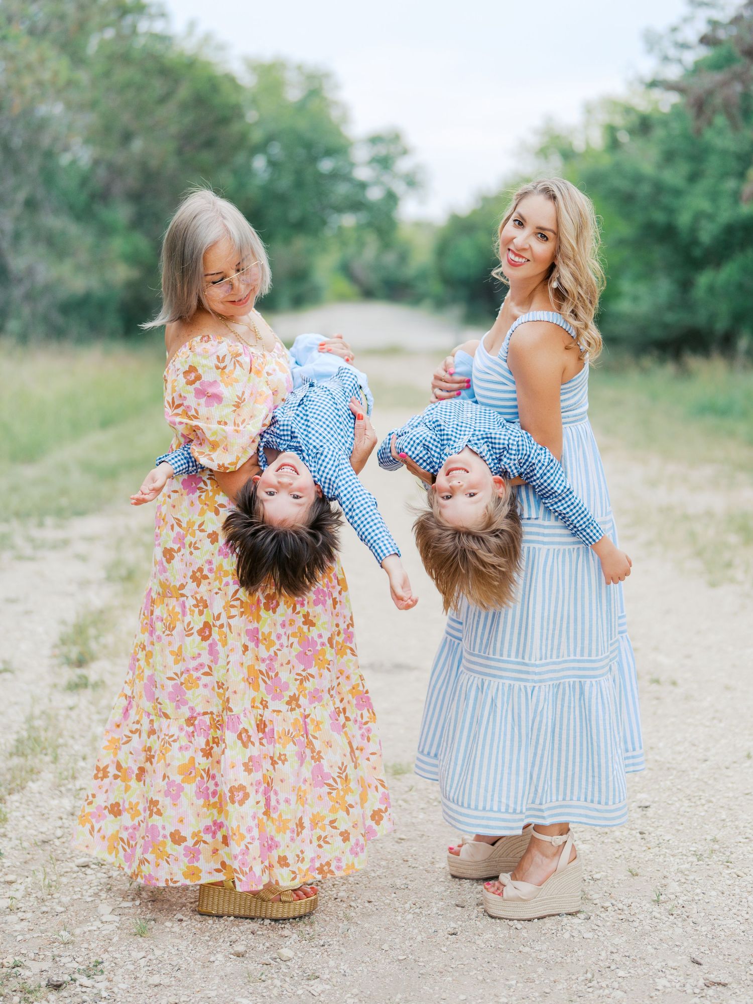 Three generations photoshoot including mom, grandma, and two kids playing.