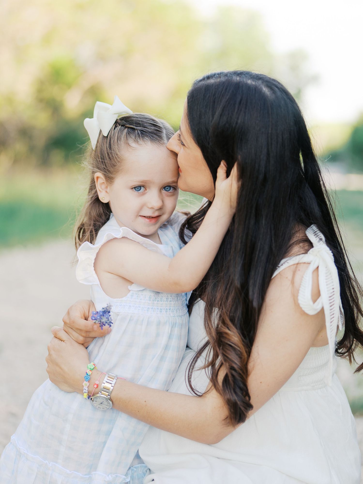 Candid Photo of Daughter hugging her mother during an outdoor family session with natural light in San Antonio, Texas
