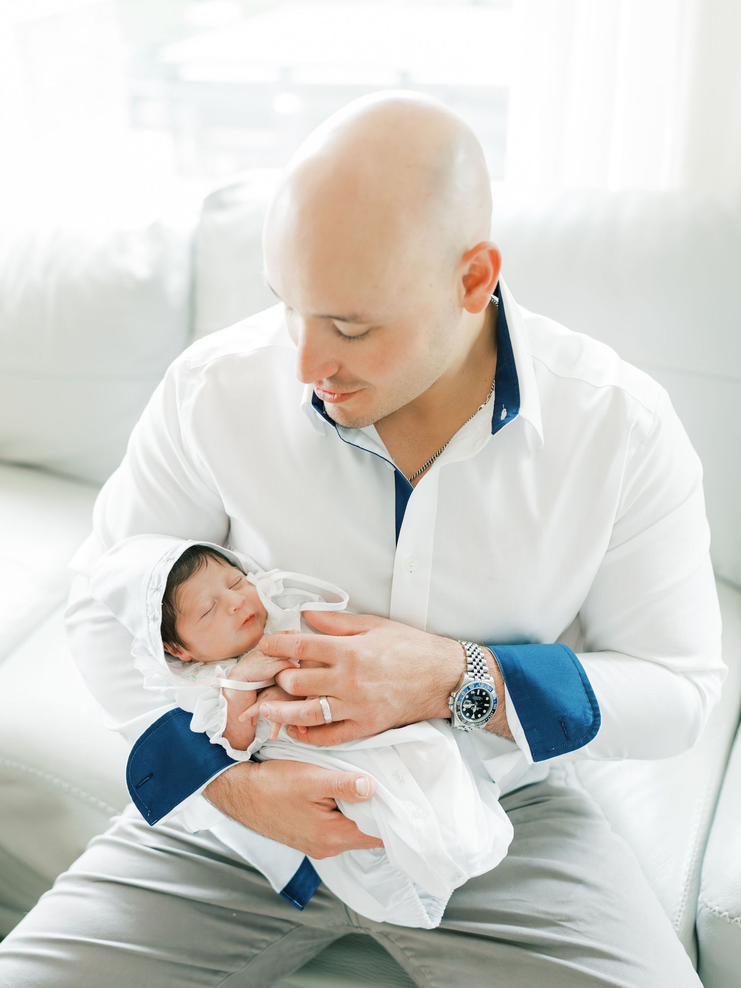Father holding his newborn baby during an in home session in San Antonio