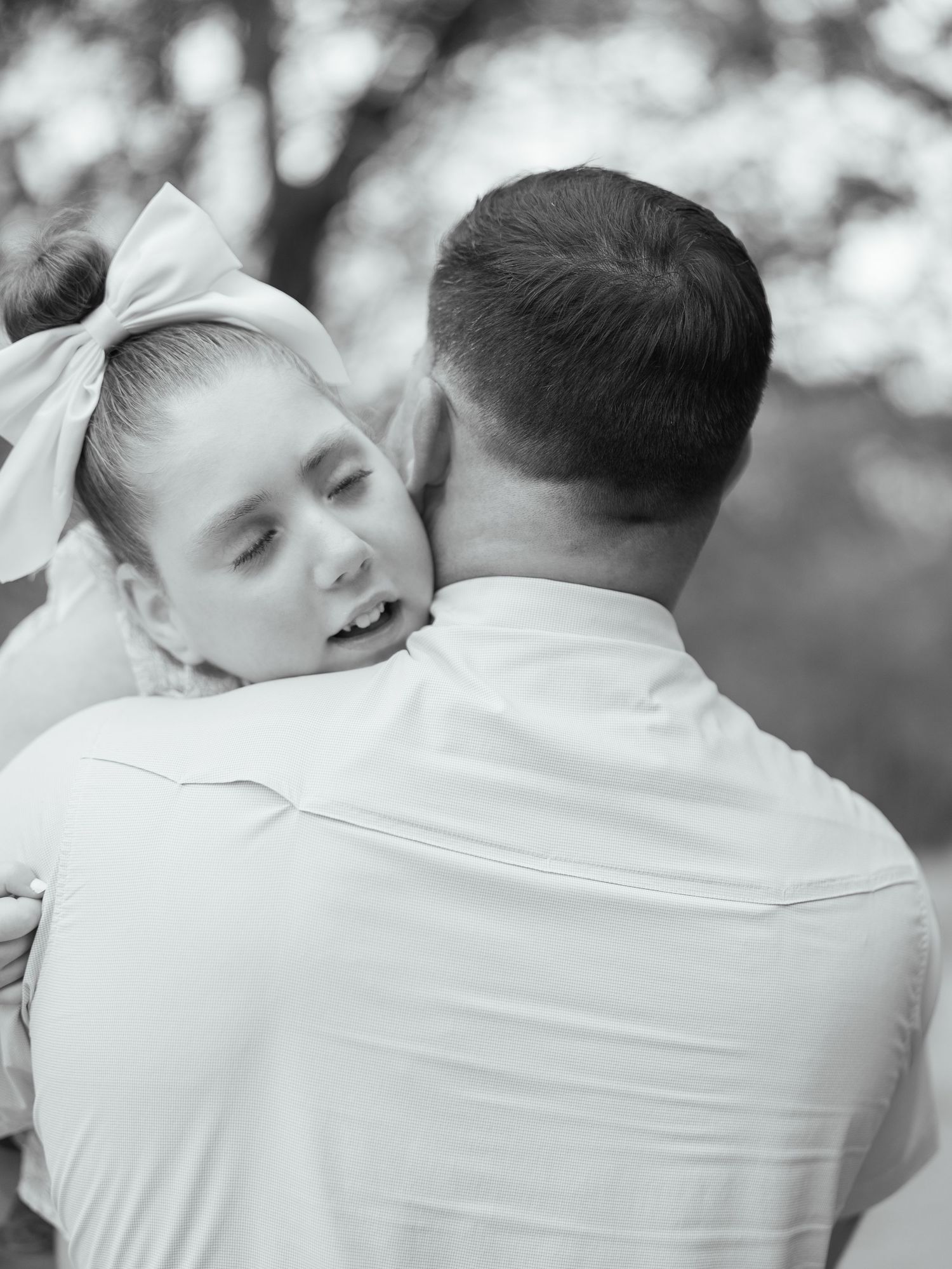 Black and white portrait of a father holding his young daughter during an outdoor family session