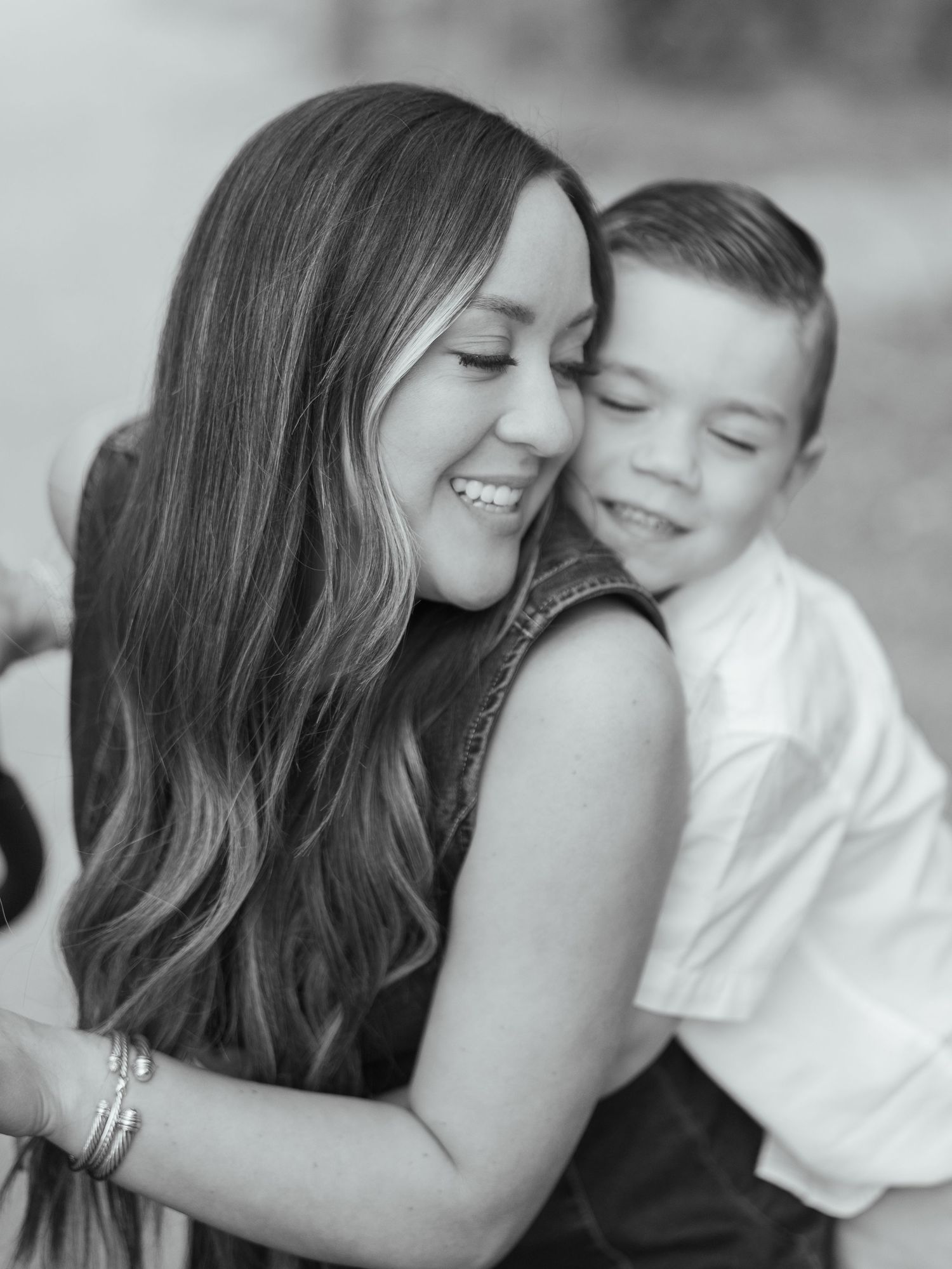 Black and white portrait of a mother hugging her young son during a family session
