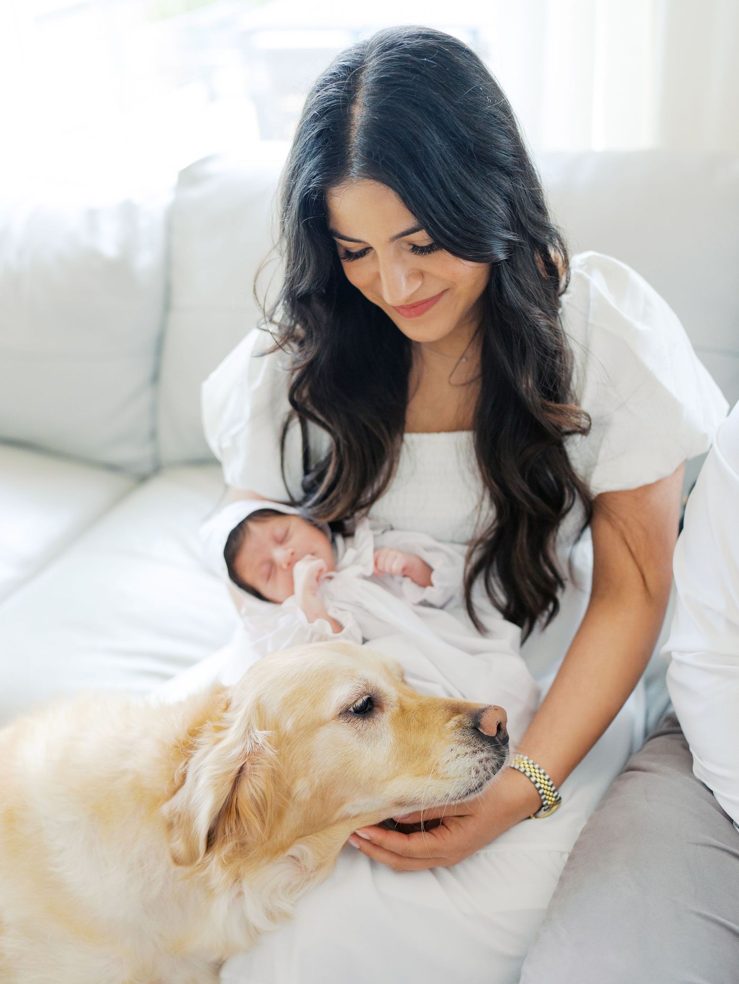 Mother with her newborn baby and family dog during an in home newborn photography session in San Antonio