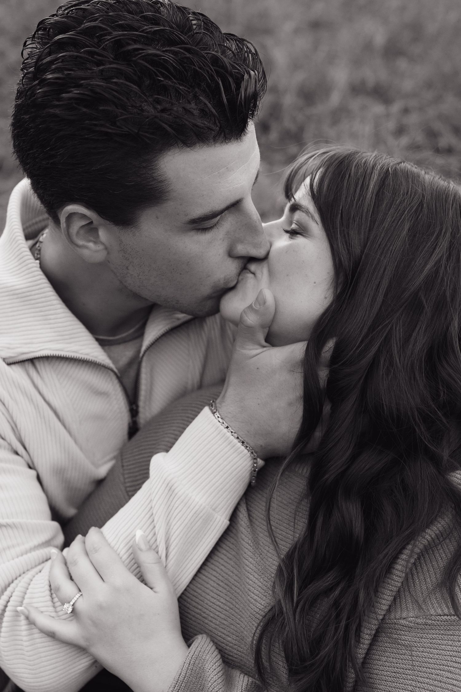 An intimate black and white portrait of a couple sharing a romantic moment.