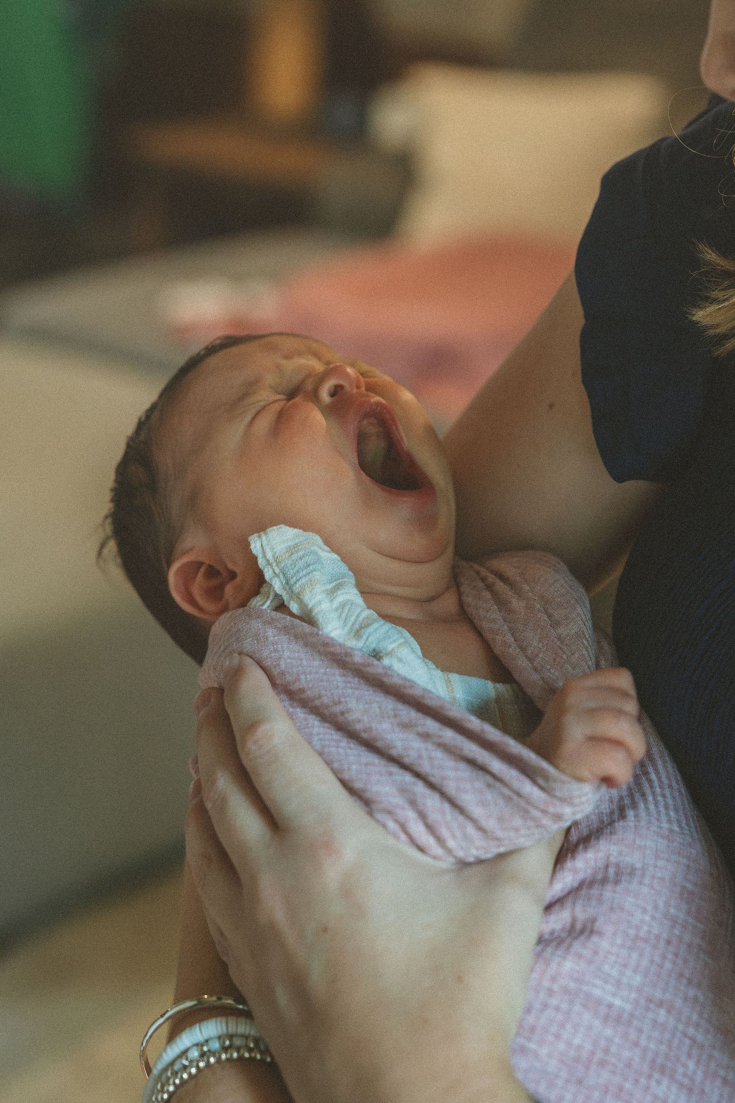 Sequence of a sleeping baby wrapped in a soft checkered blanket.