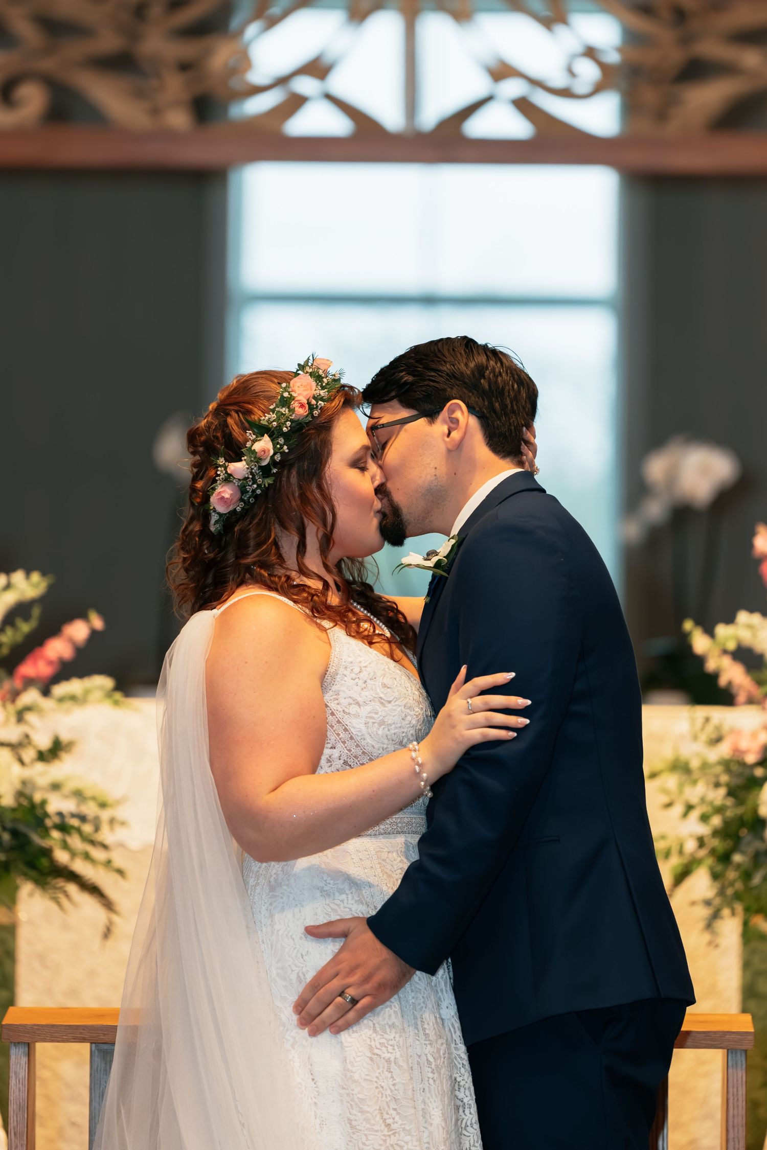 Intimate wedding ceremony moment in an elegant wood-paneled venue.