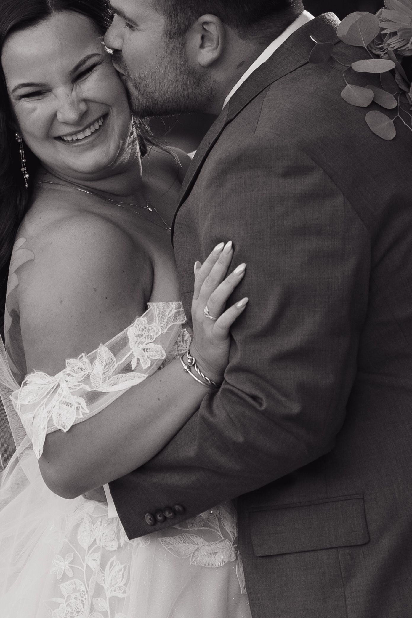 Black and white wedding portraits showing tender moments between newlyweds.