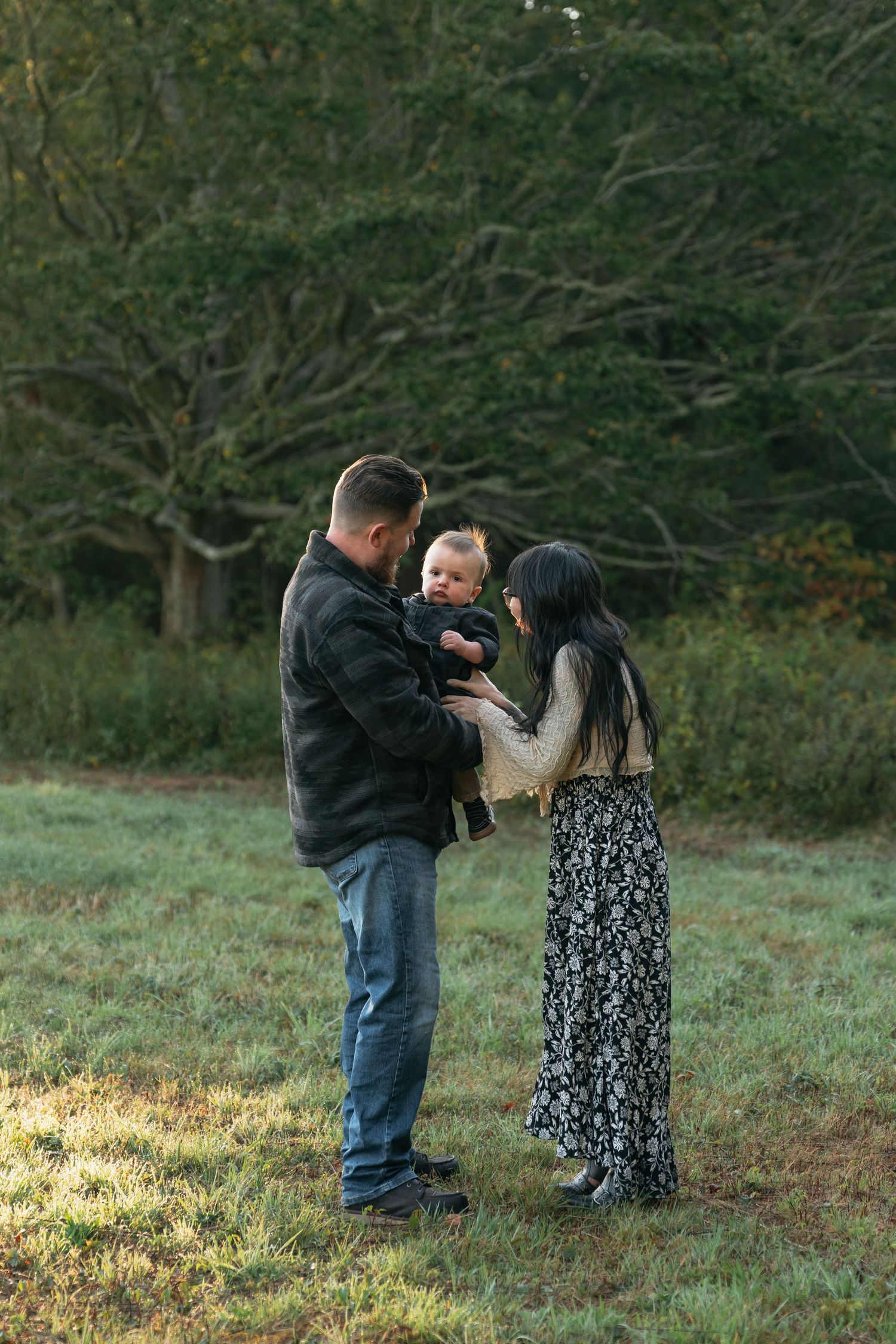 Family enjoying candid moments together during golden hour photo session.