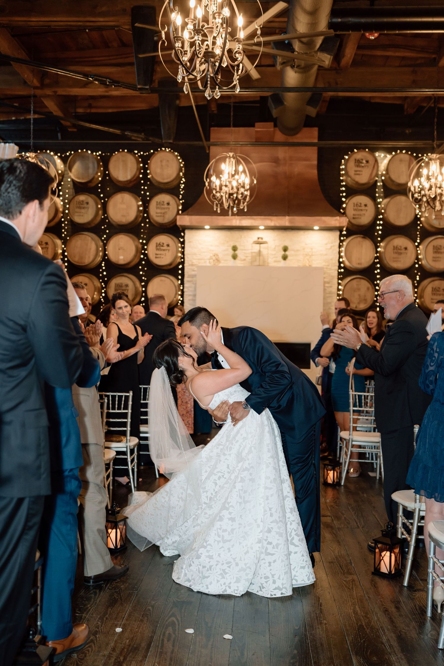 First dance sequence in elegant winery reception space with romantic lighting.