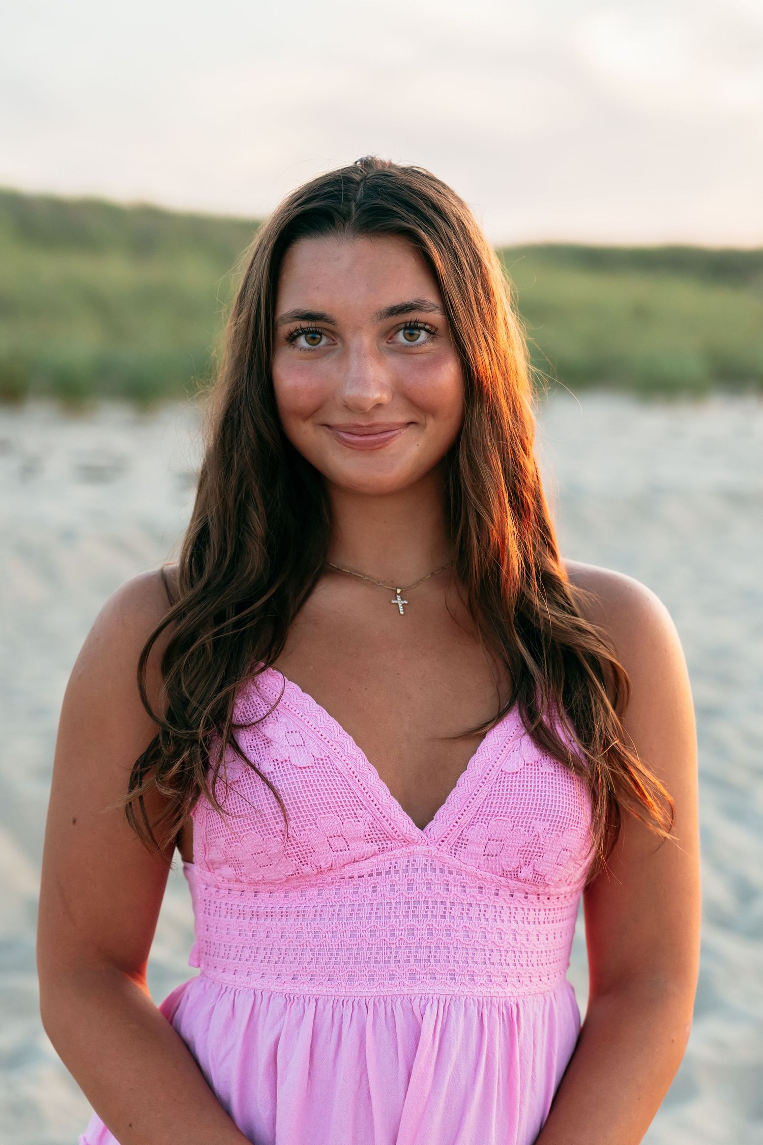 Casual beach portraits in pink smocked sundress at sunset.