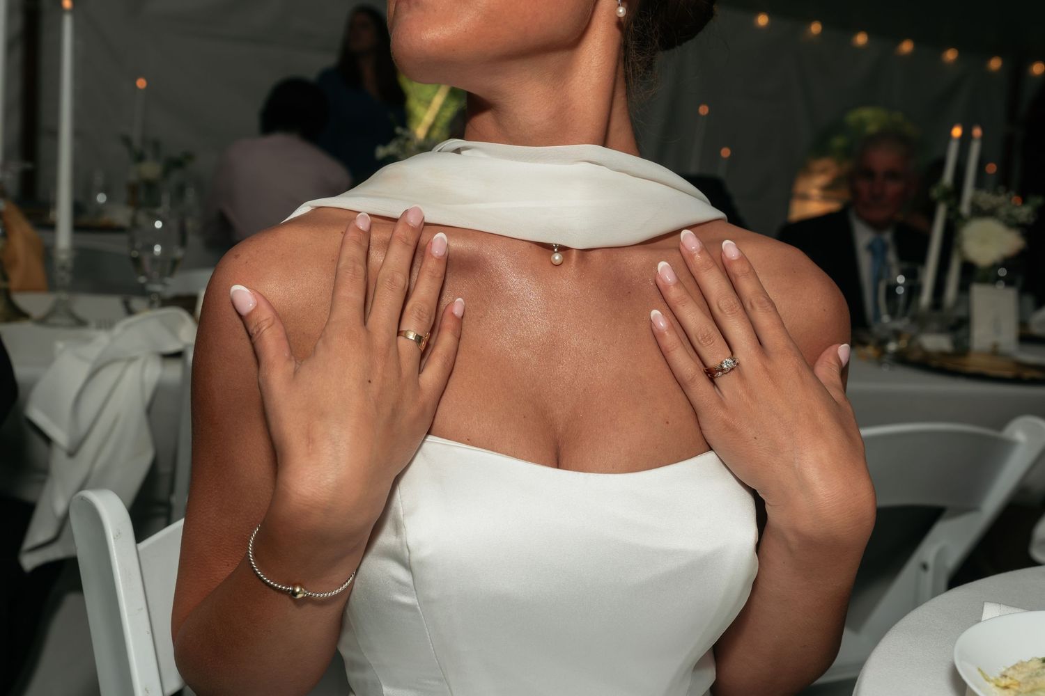 Close-up details of a white strapless wedding dress bodice.